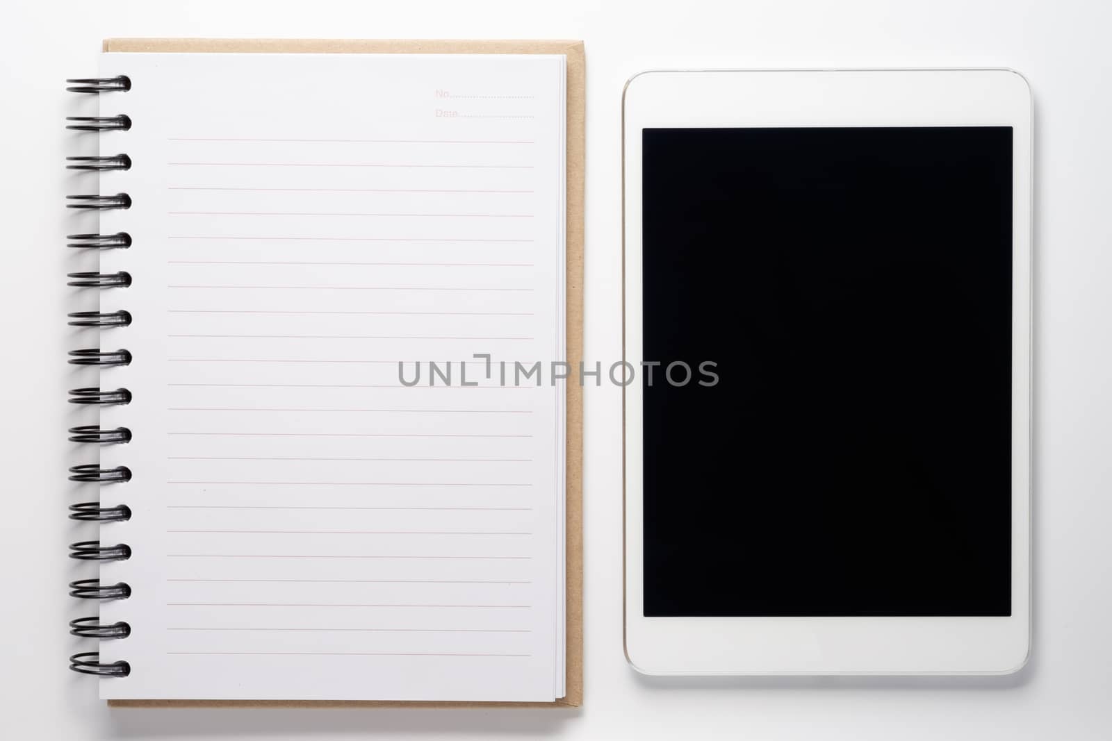 Notebook and tablet on white background.
