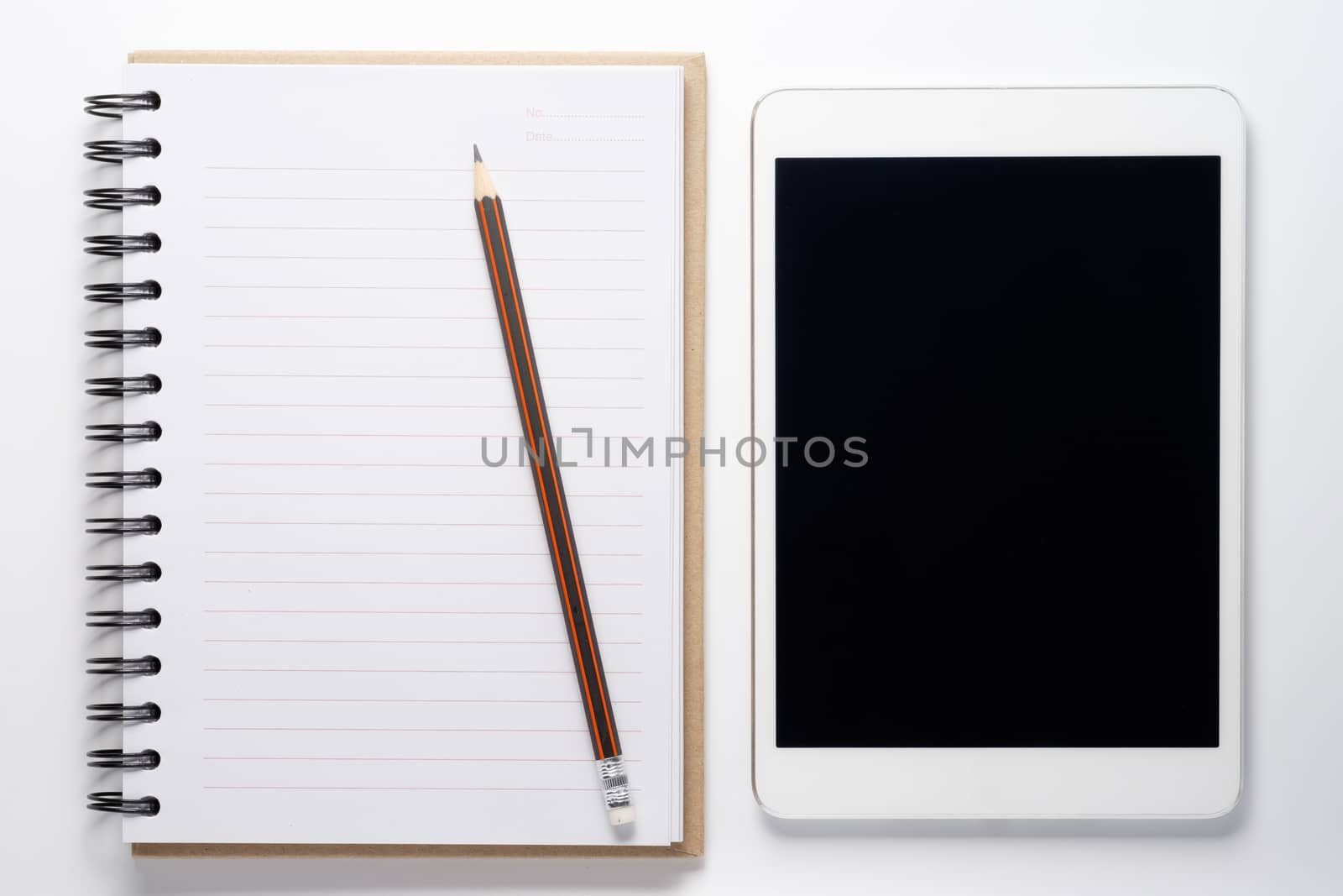 Notebook and tablet on white background.