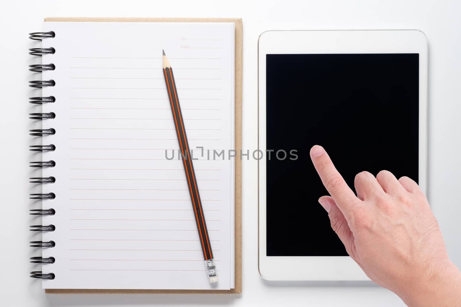 Notebook and tablet on white background with hand touch on tablet screen