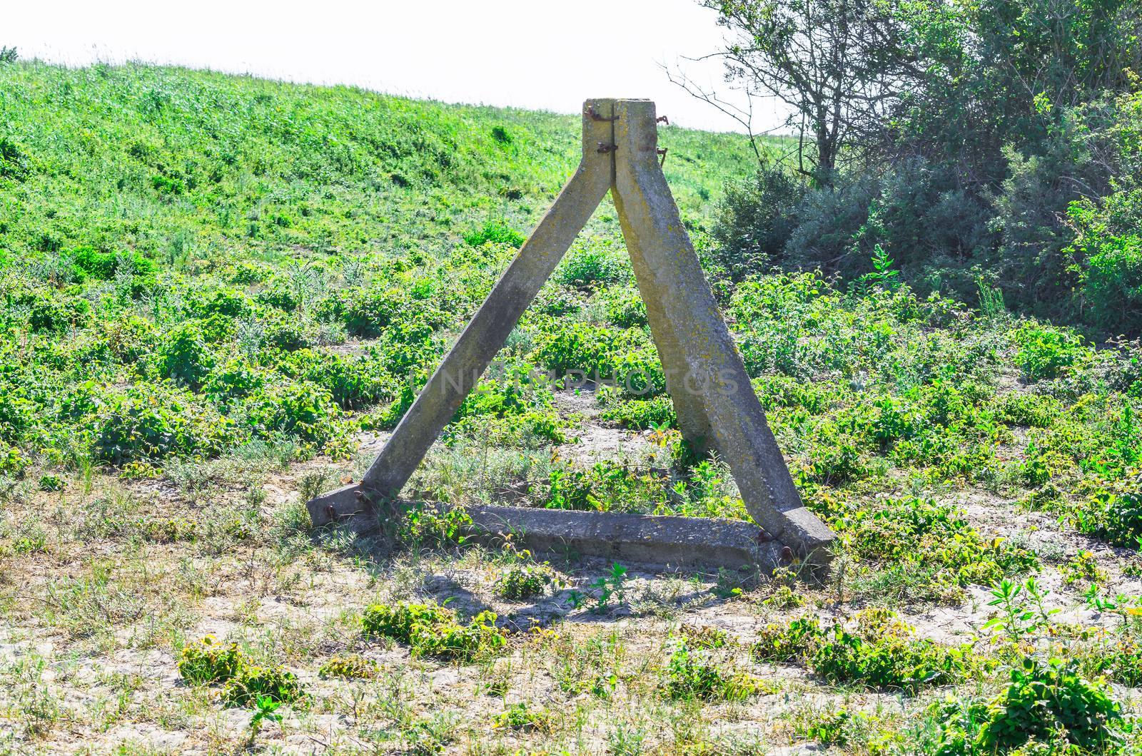Real concrete tank barriers on the beach. Also called Czech hedgehogs. From the period of World War II on a beach at the Western Wall.