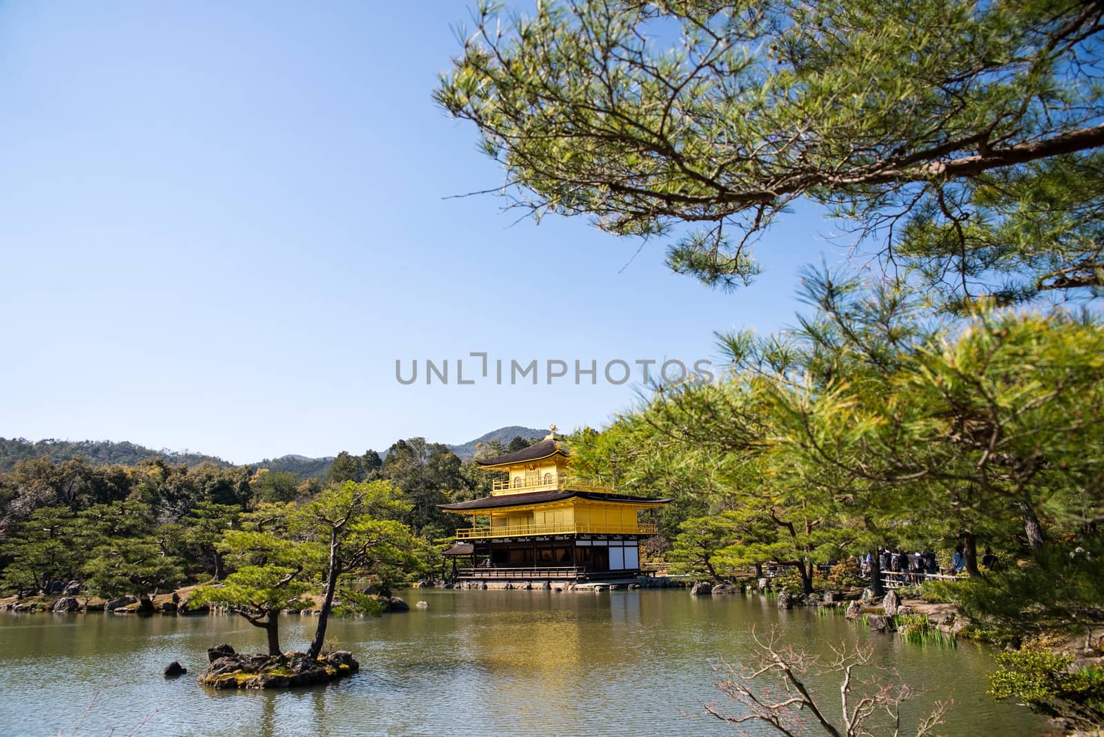 Kinkakuji (Golden Pavilion) is a Zen temple in northern Kyoto whose top two floors are completely covered in gold leaf.