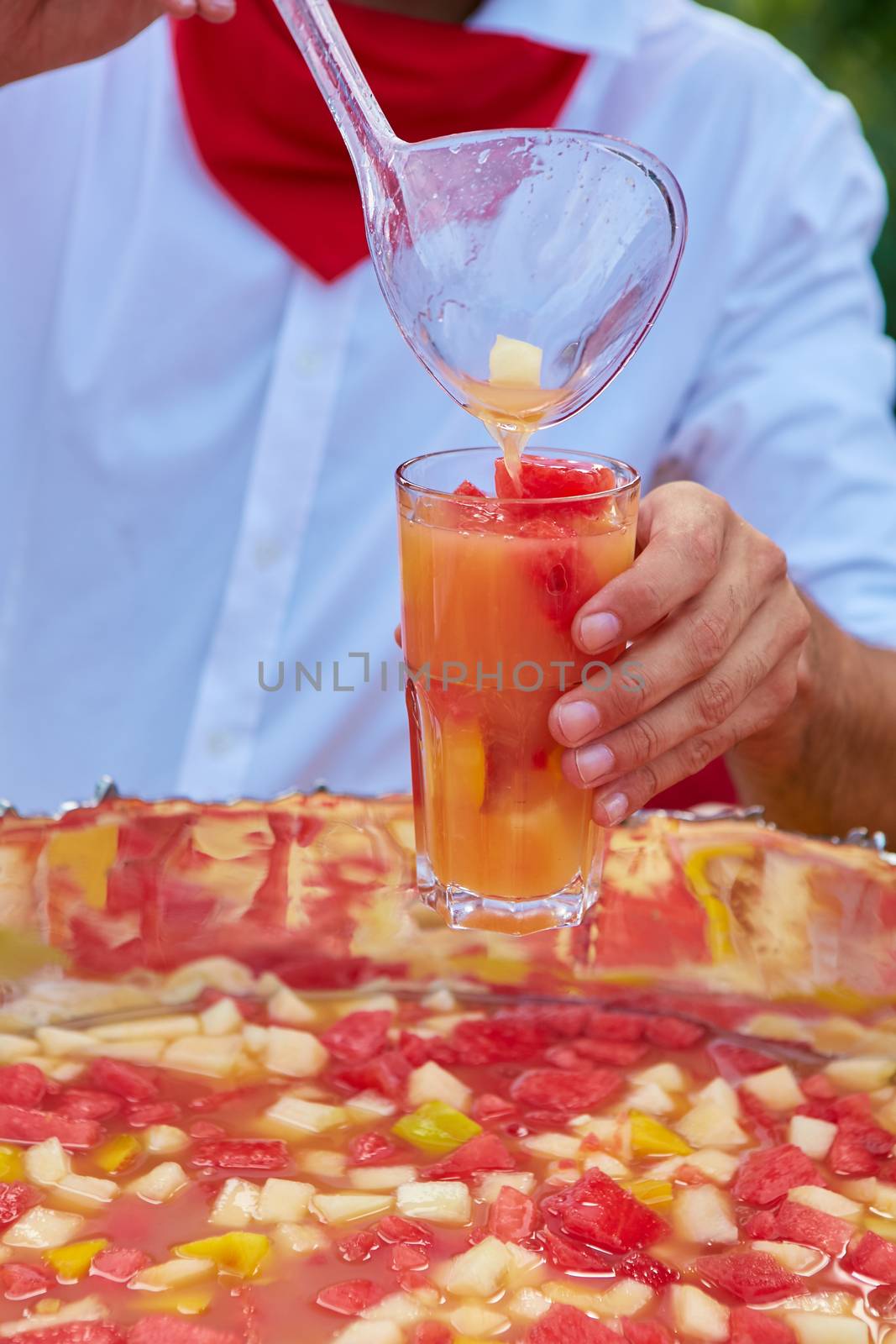 mixed punch with fresh fruits in metal bowl