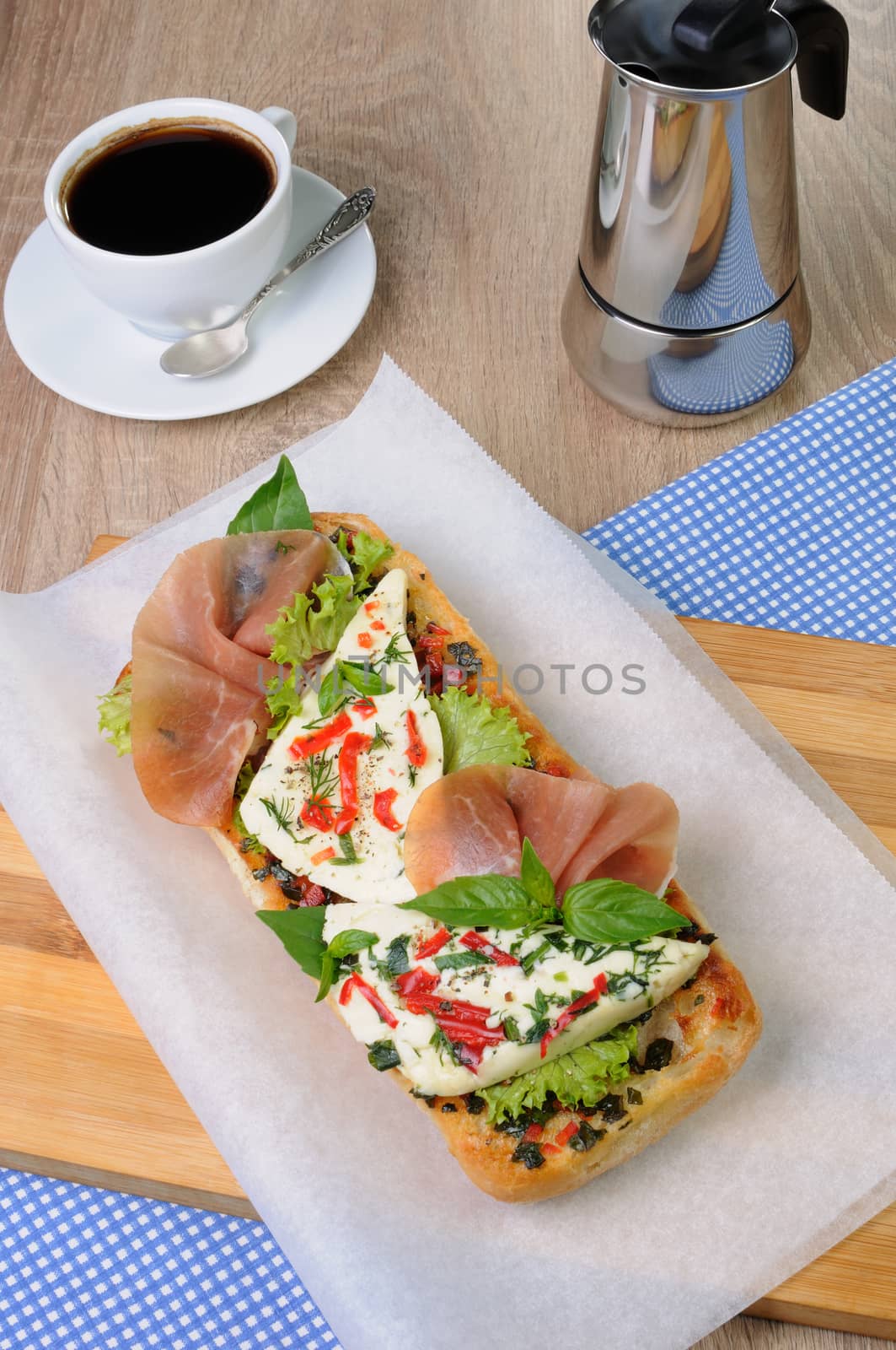 Sandwich with mozzarella and jamon on ciabatta with a cup of coffee