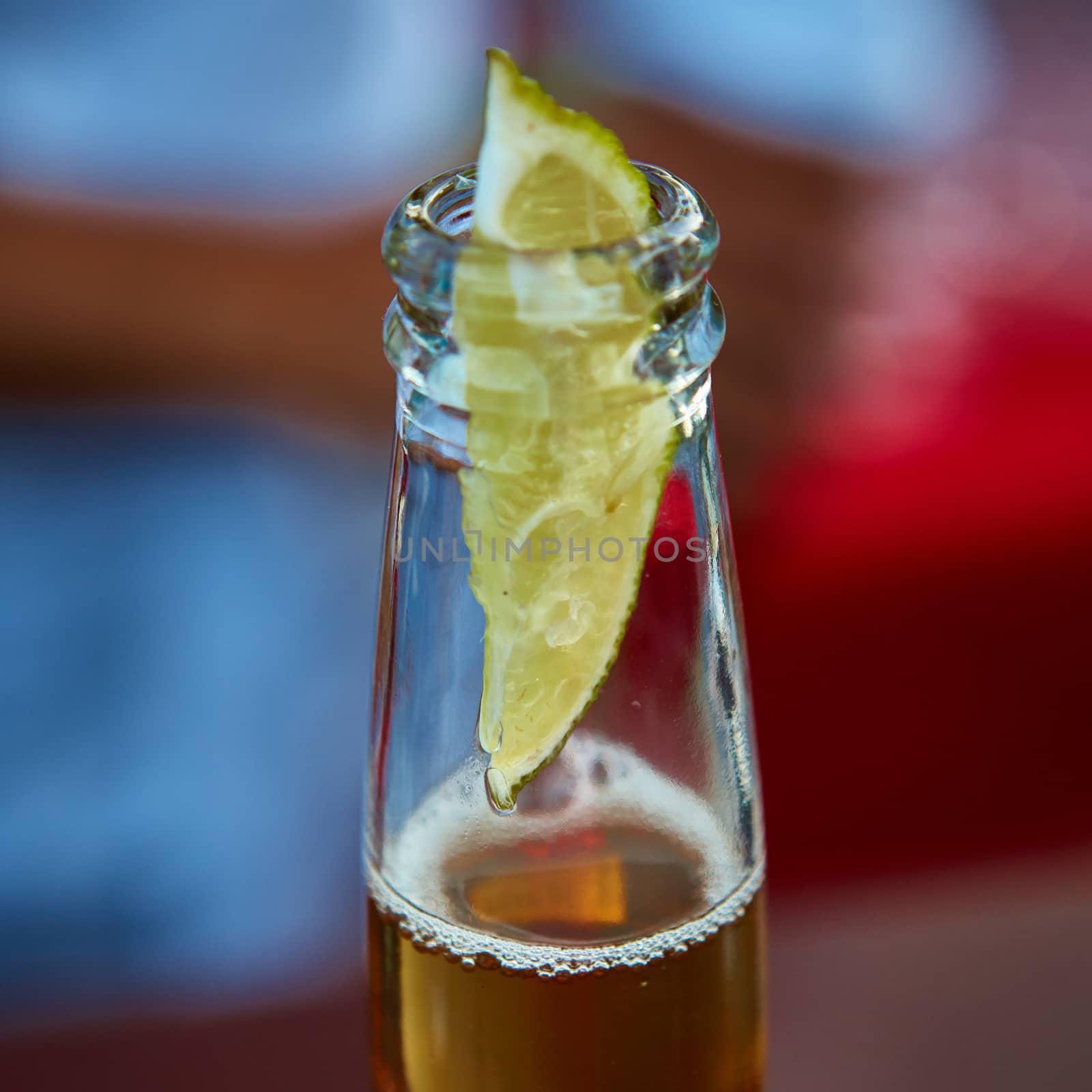 Beautiful ice cold beer in a bottle with a wedge of fresh lime