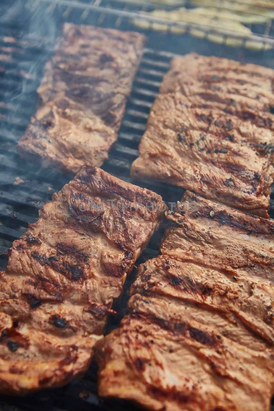 Grilled pork ribs on the grill. Shallow dof