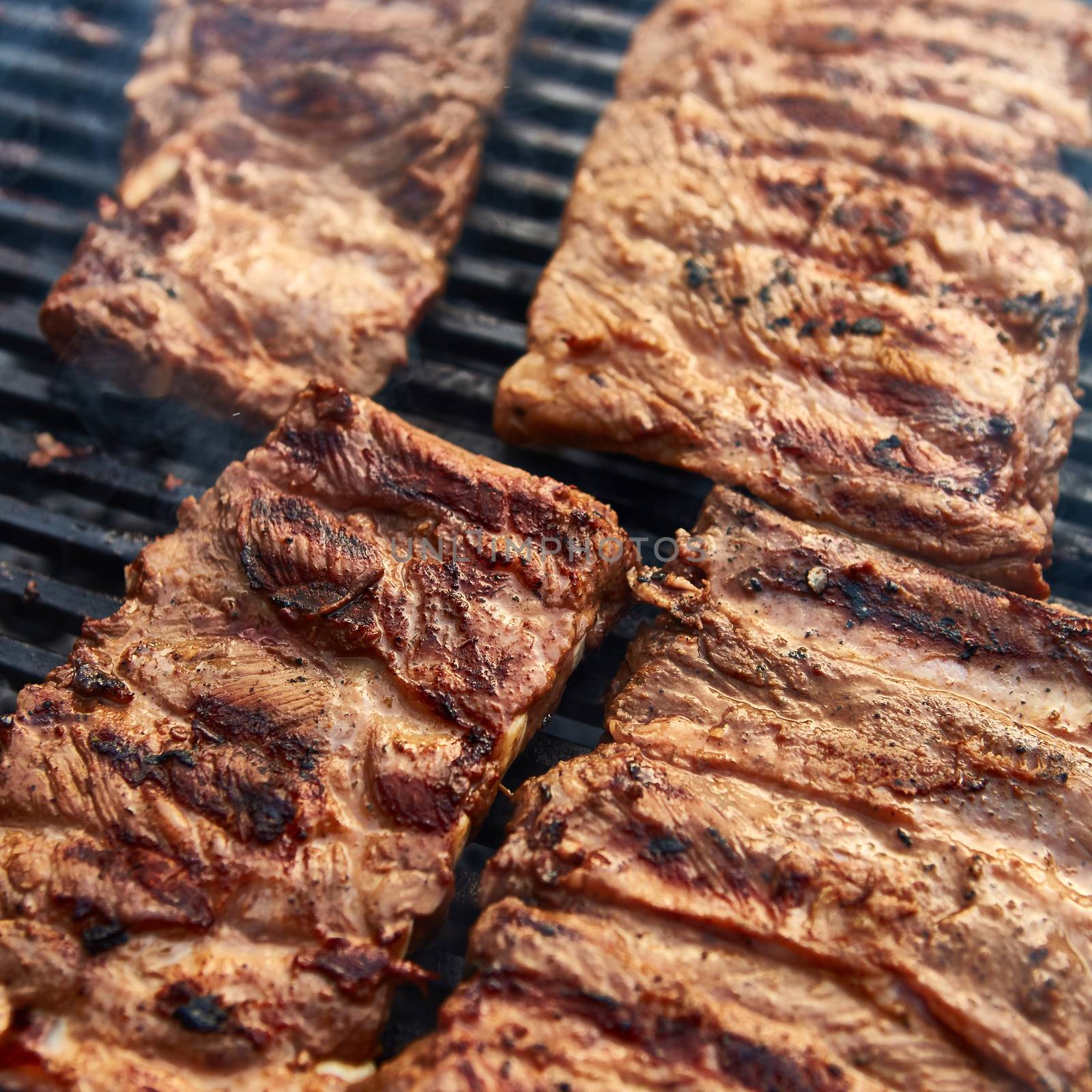 Grilled pork ribs on the grill. Shallow dof