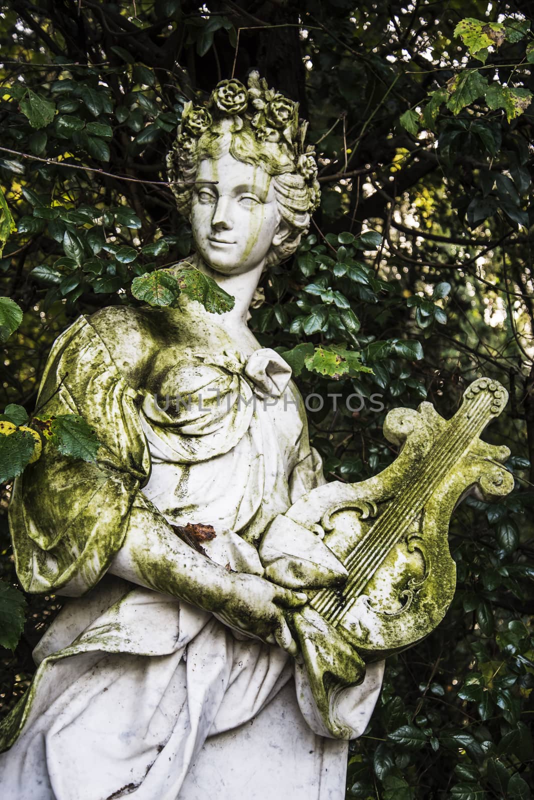 Old statue inside the Royal Palace garden in Caserta, Italy 
