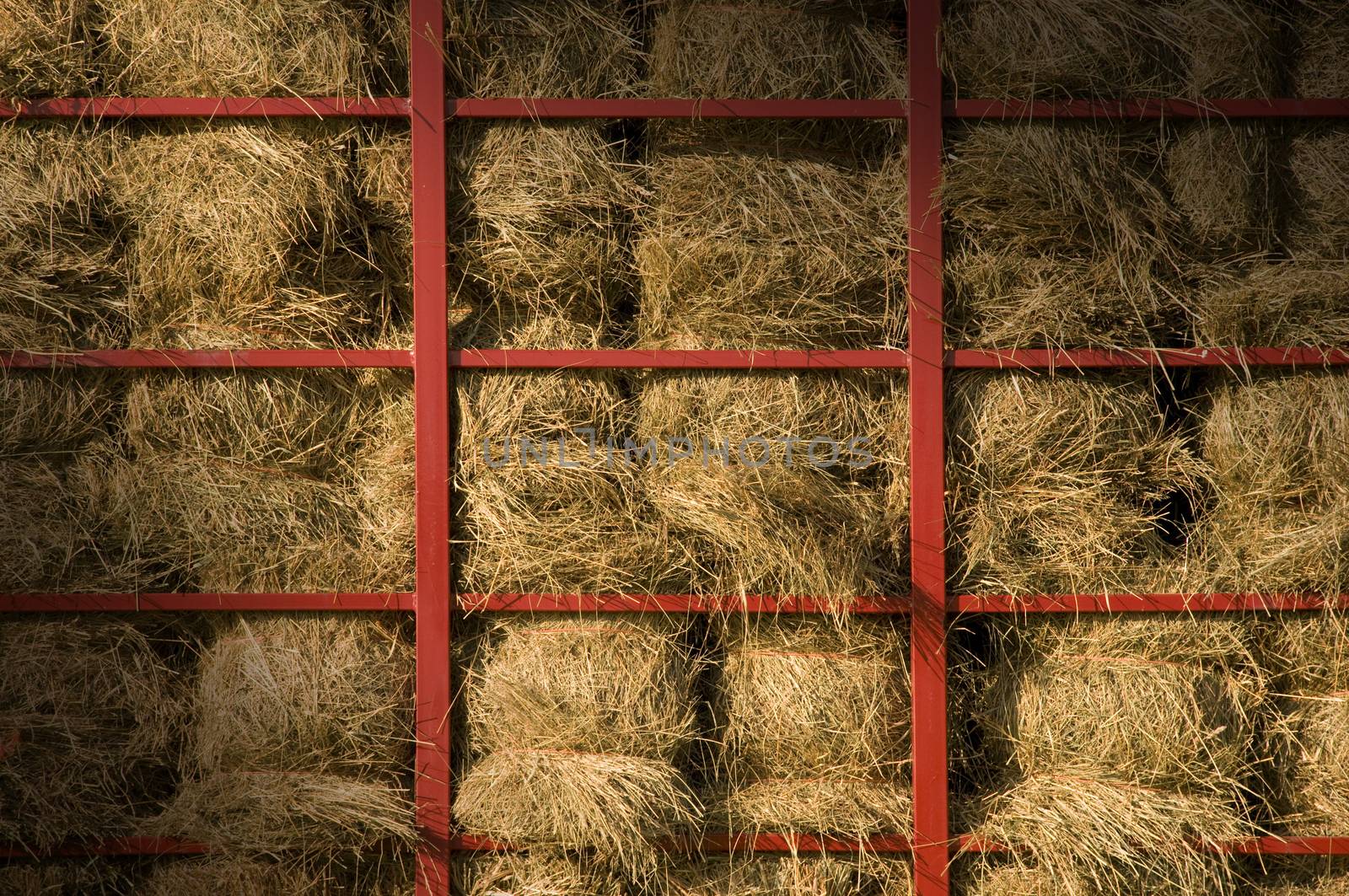 Hay bales piled within a cart lit diagonally by Balefire9
