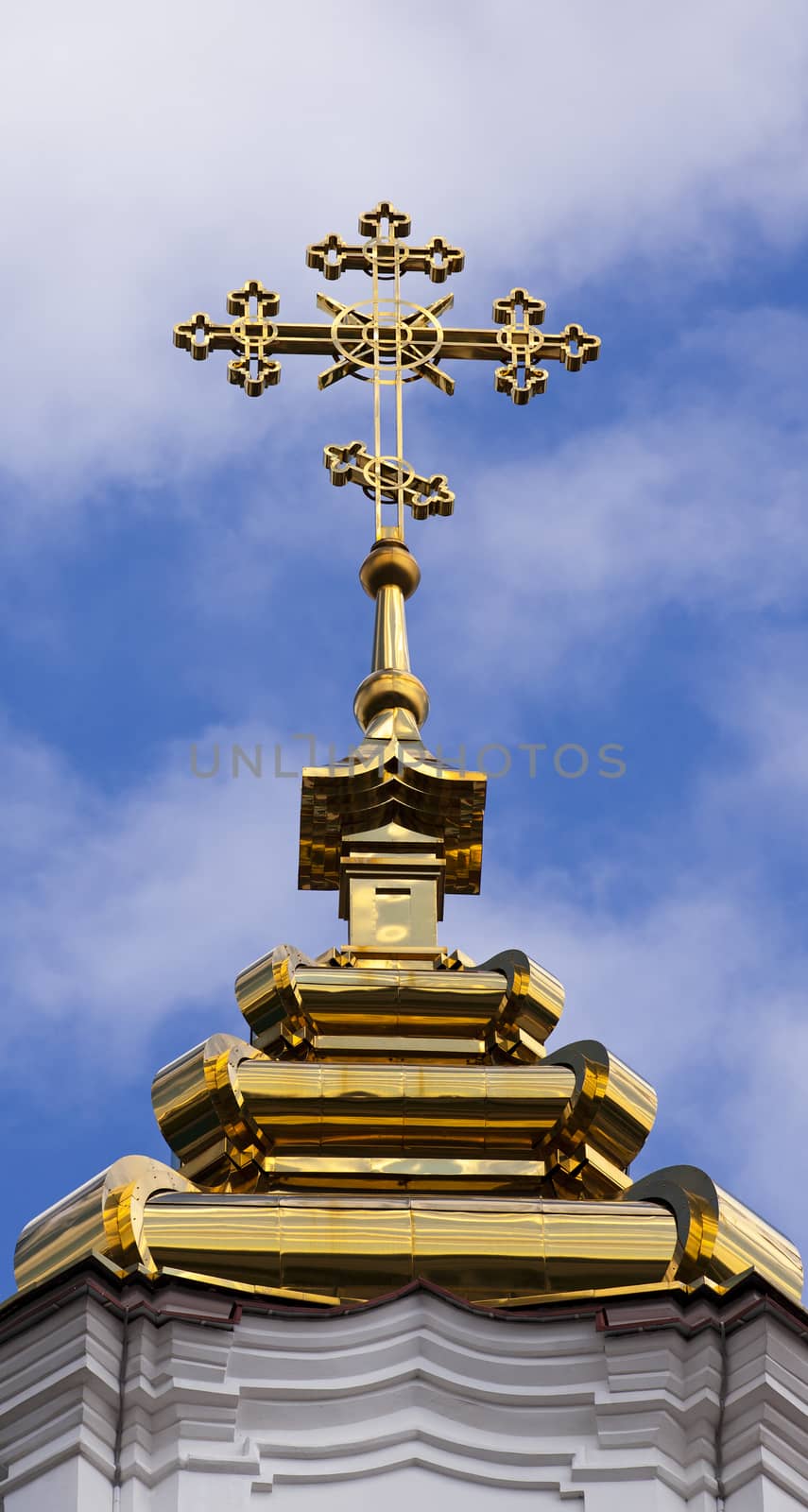   the gilded orthodox cross which is settling down on church