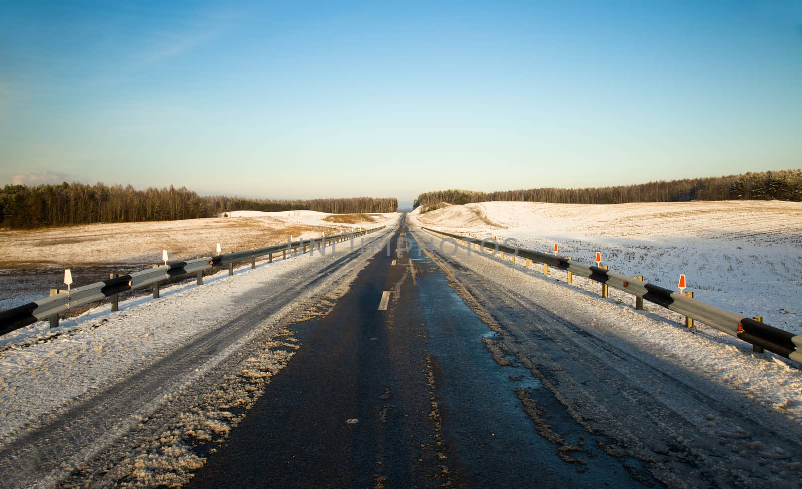 a small road in winter .  landscape