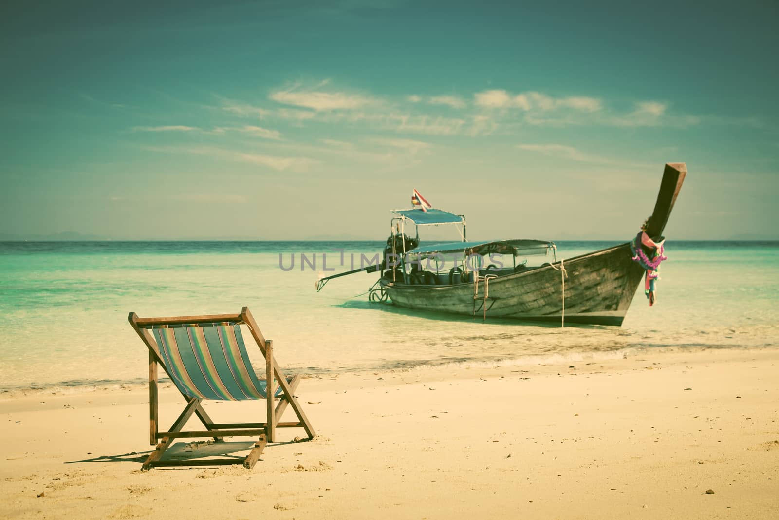 Exotic beach holiday background with beach chair and long tail boat - Thailand ocean landscape