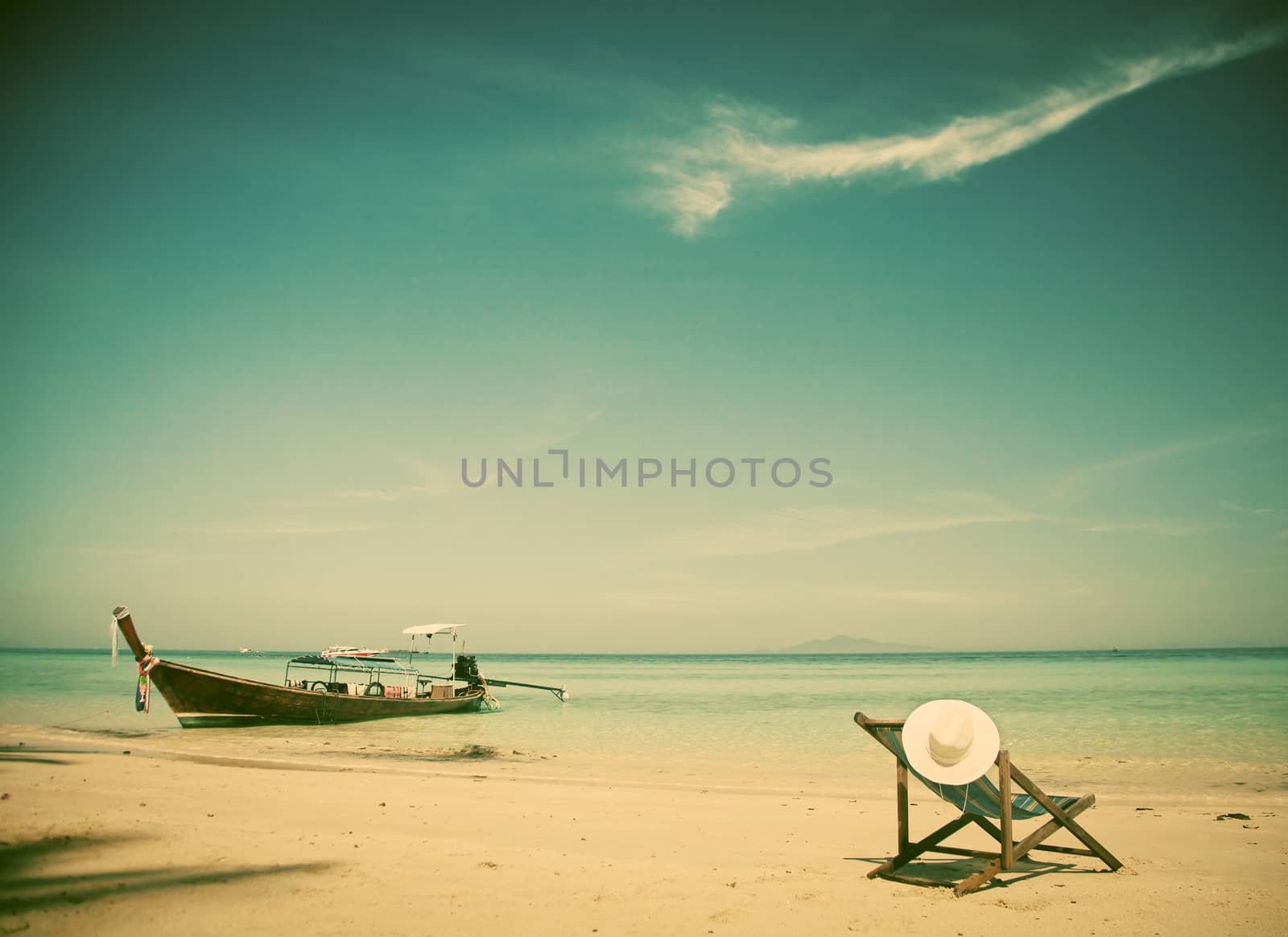 Exotic beach holiday background with beach chair and long tail boat - Thailand ocean landscape