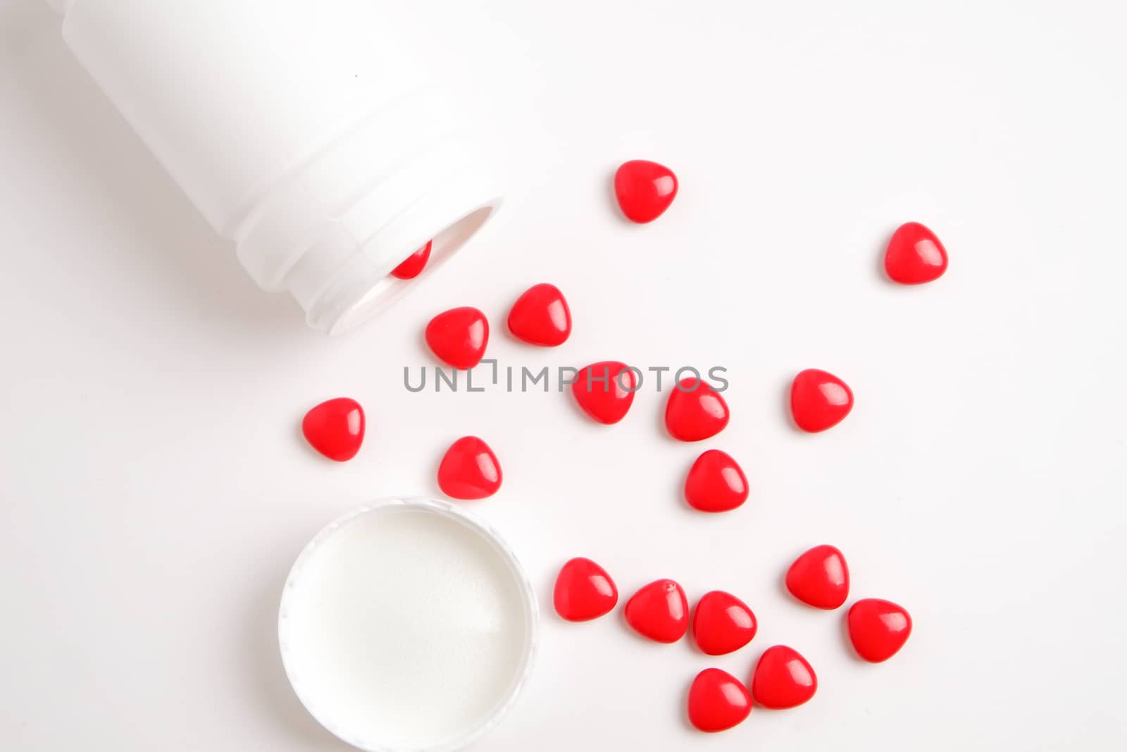 red pills on white table by zneb076