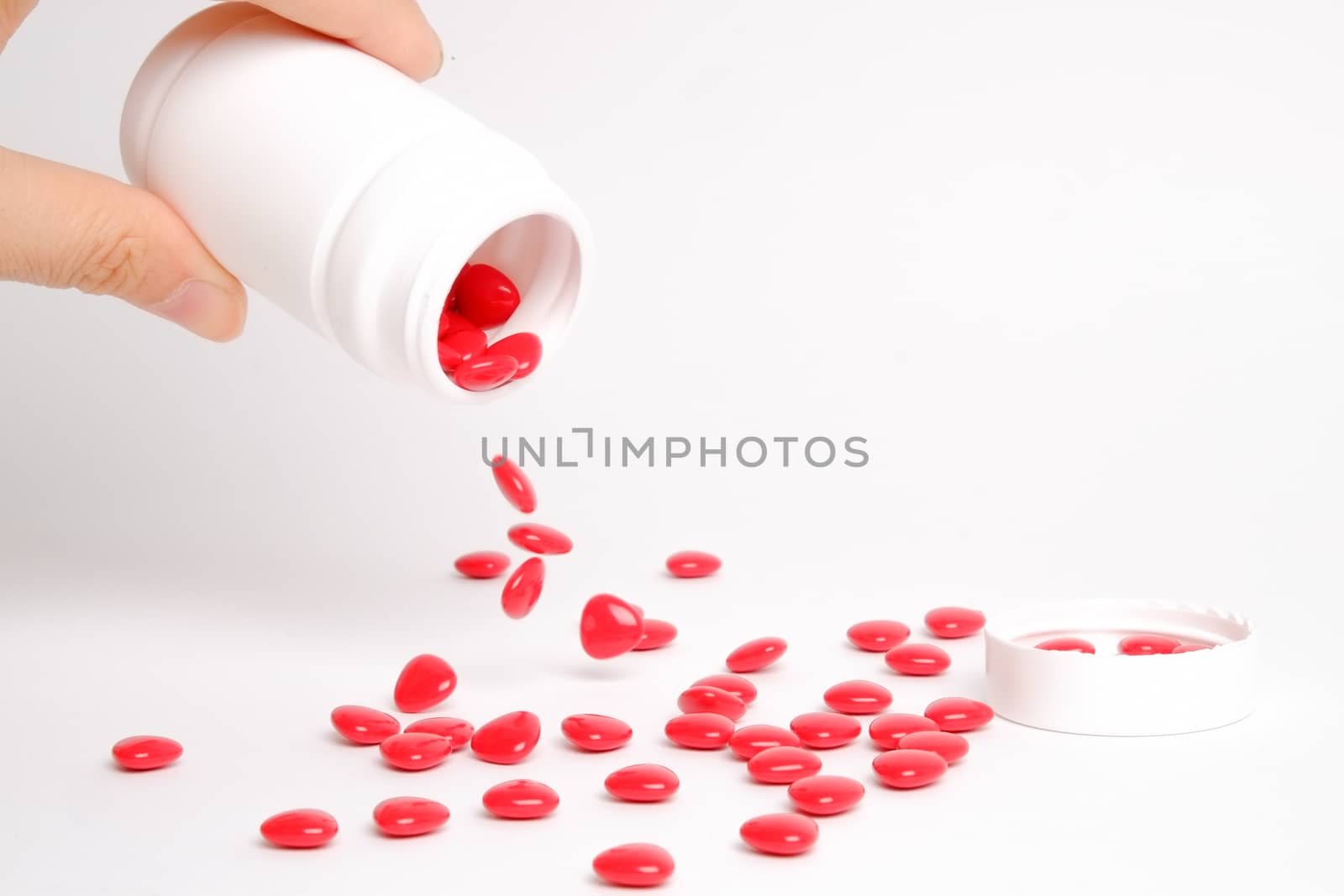 red vitamin (medicine) on white table