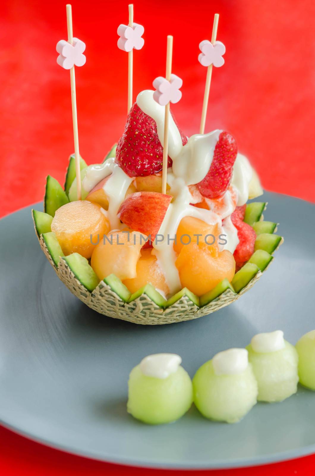 Fresh Fruit Salad in Cantaloupe Bowl on dish