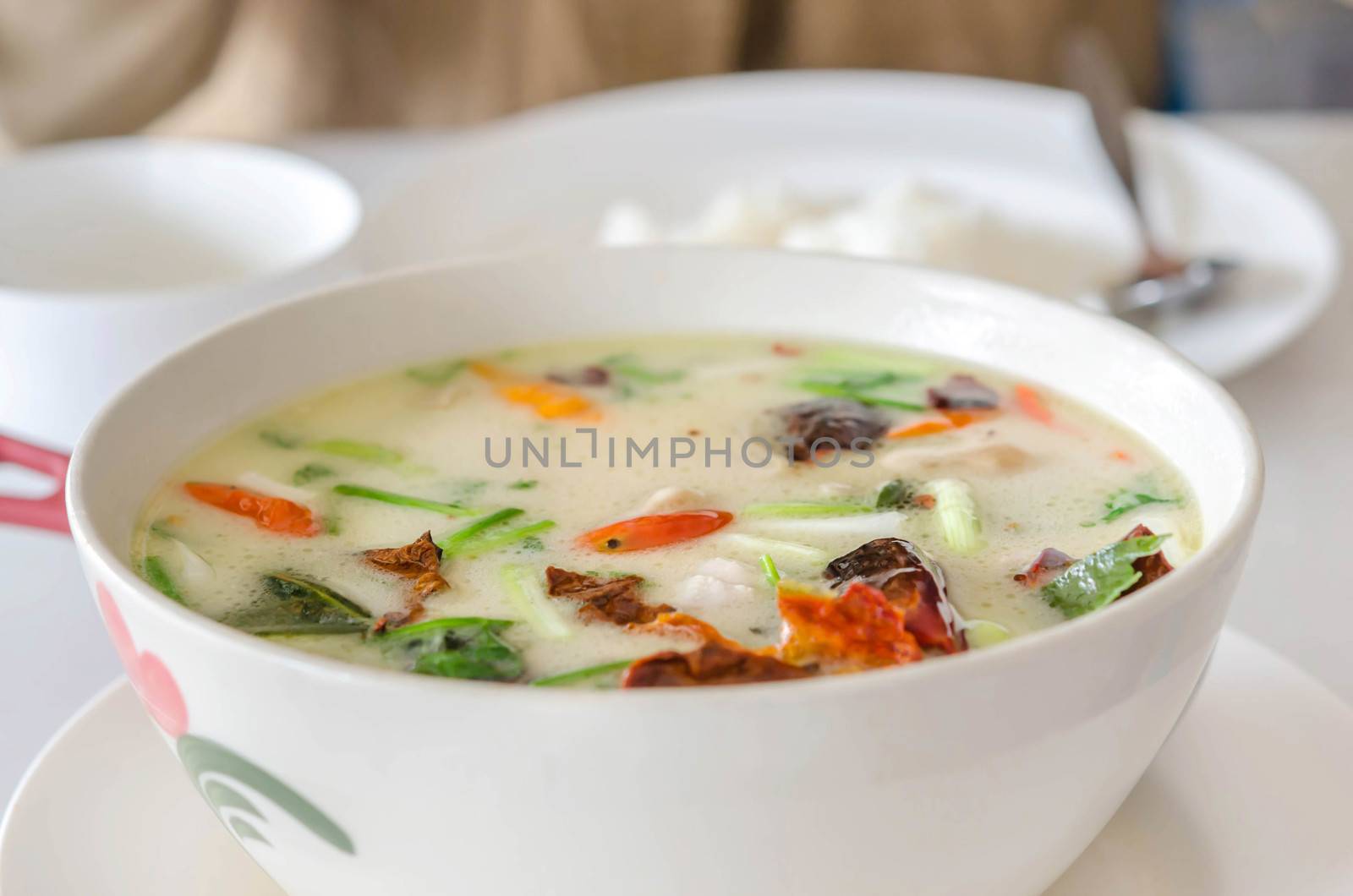 Thai  spicy chicken soup in coconut milk ,mushrooms, intensely flavor of galangal, lemongrass, kaffir lime leaf, cilantro