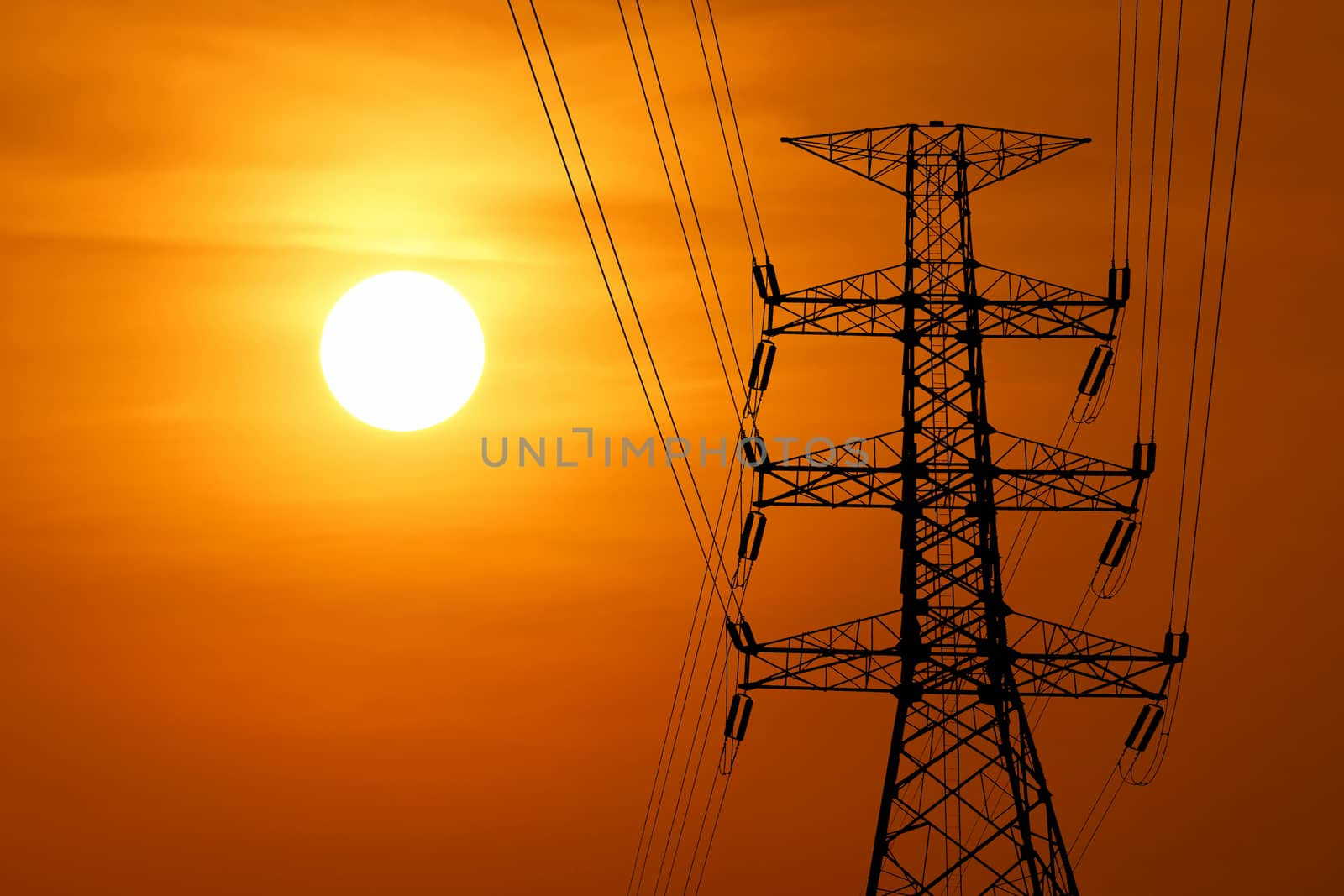silhouette of high voltage electric tower with beautiful sunset  background