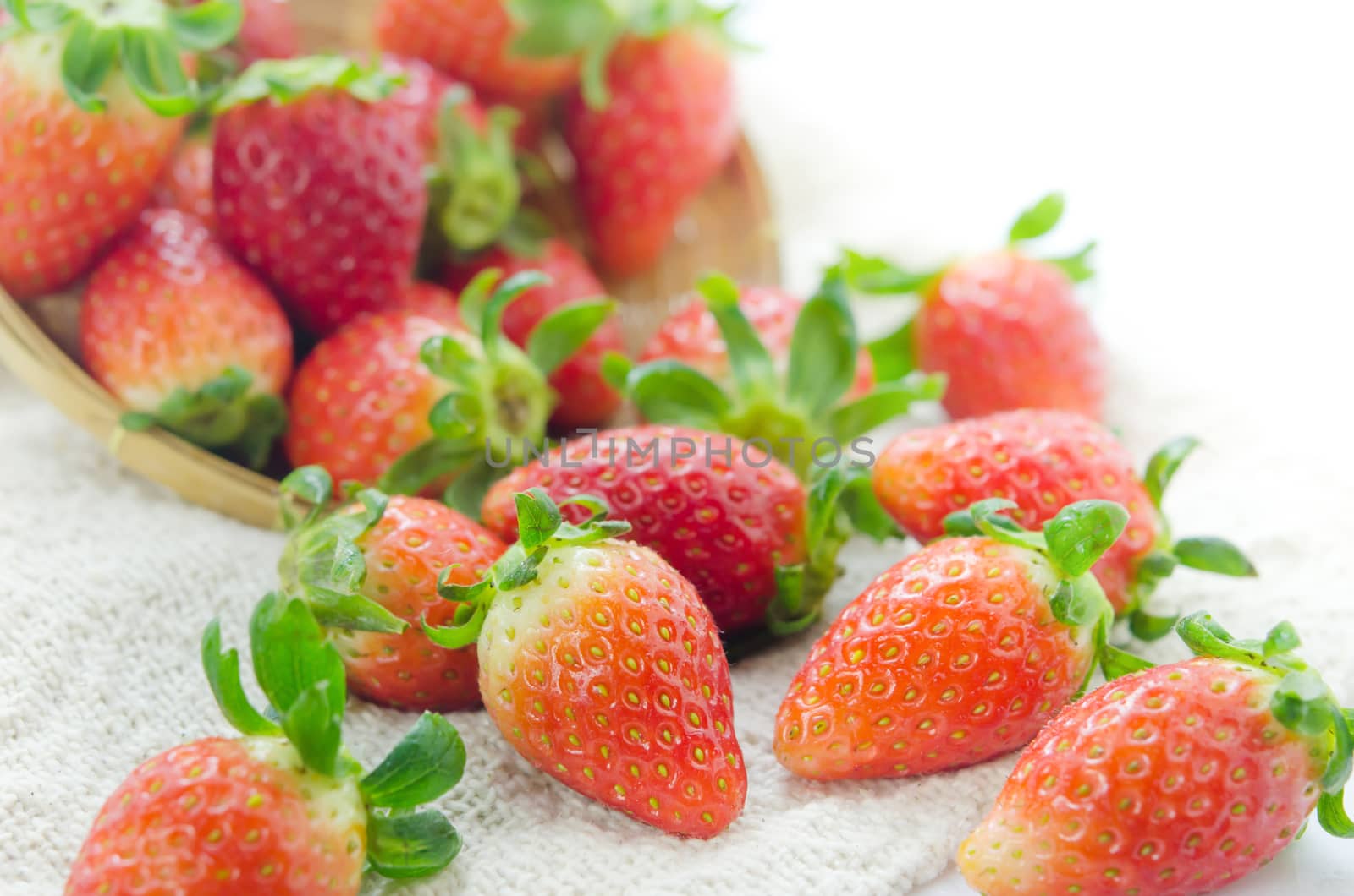 close up fresh red strawberries over sackcloth , ripe fruit