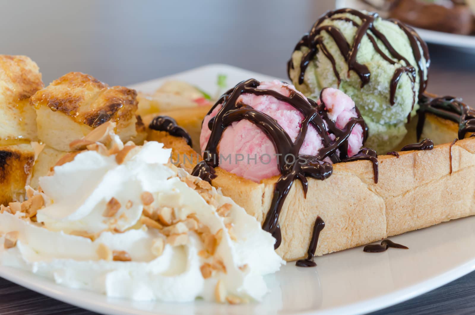 Honey toast and whipping cream with chocolate  sauce and ice cream
