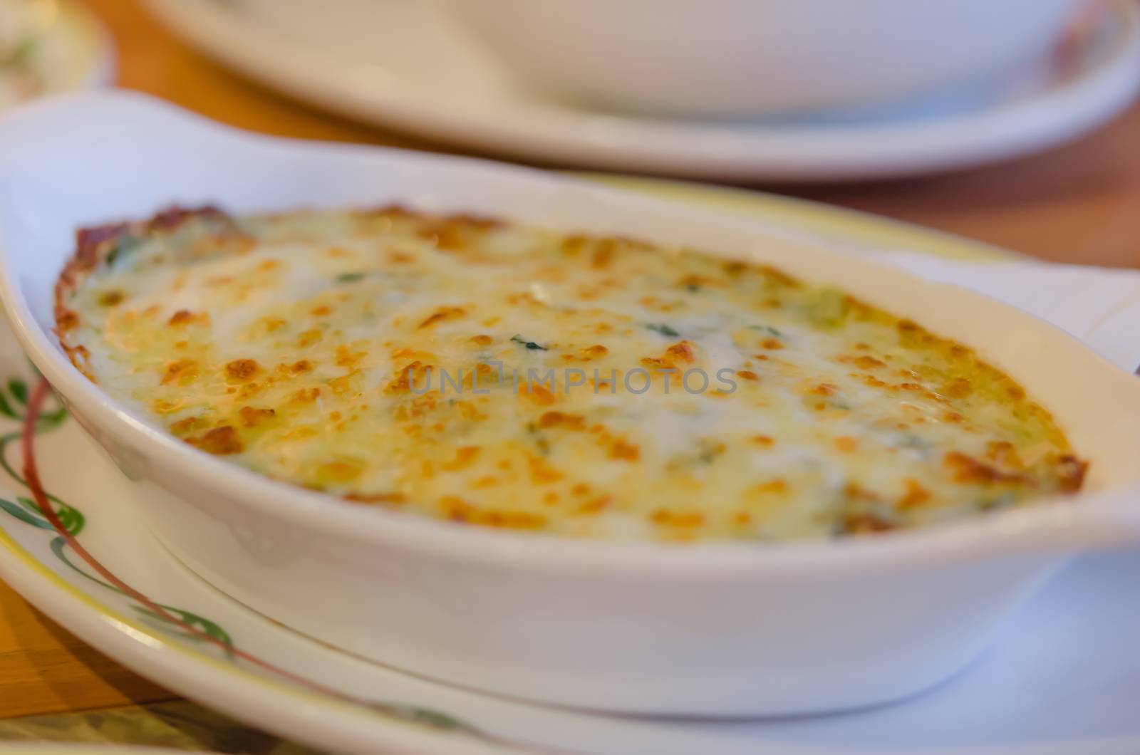 close up Baked spinach with cheese in white bowl