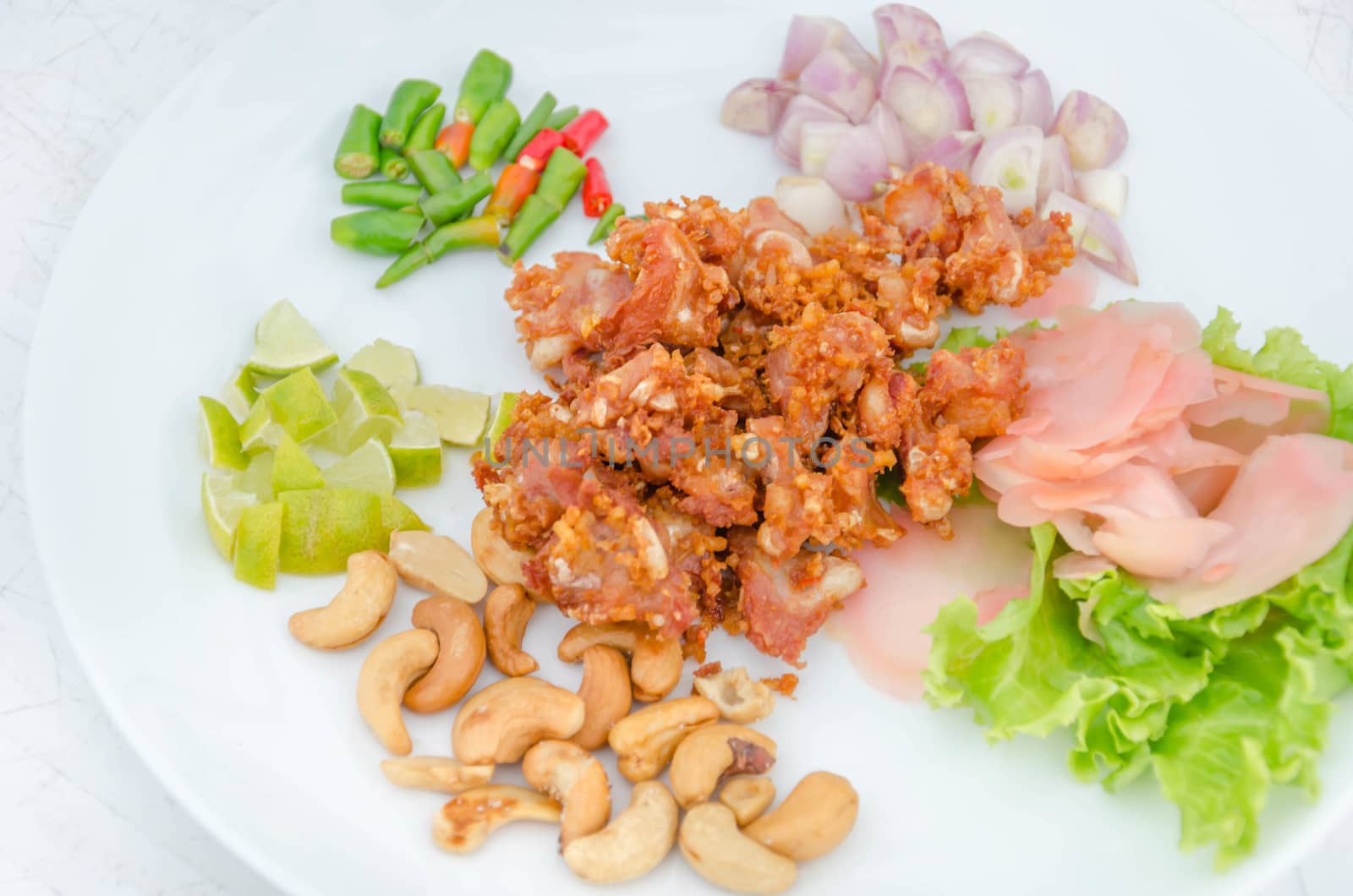 Deep fried sour fermented chicken knees tendon served with vegetables  sliced