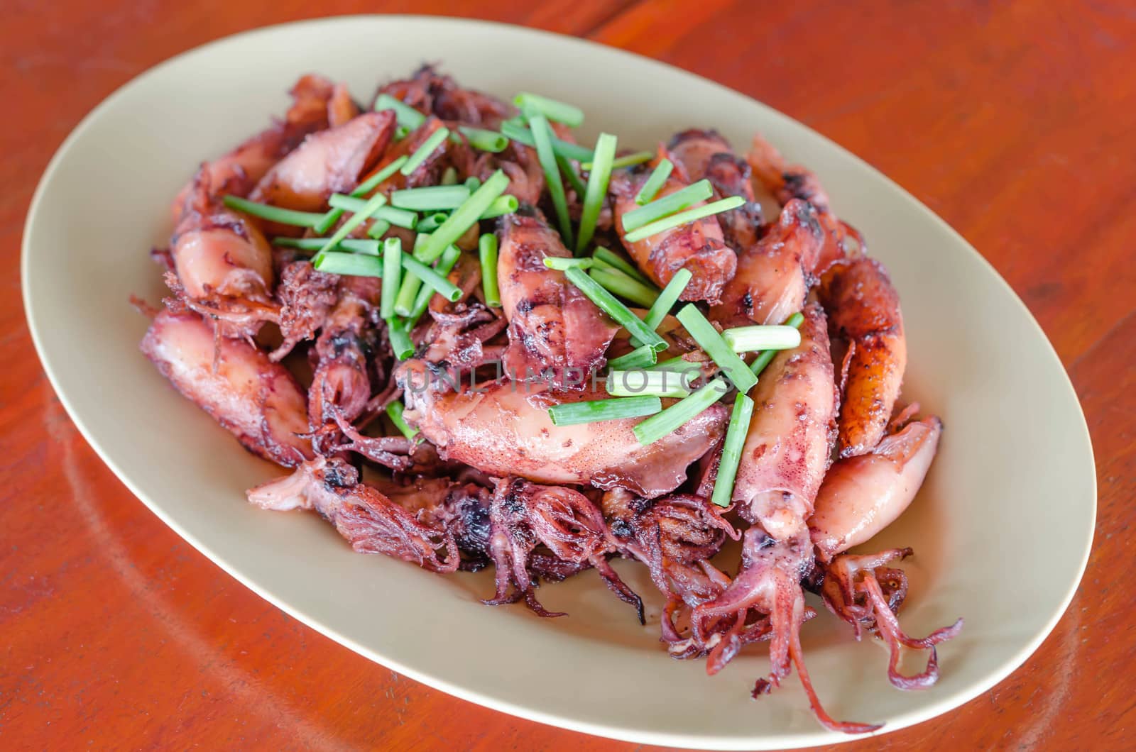 plate of sauteed small squid fried with garlic and sauce