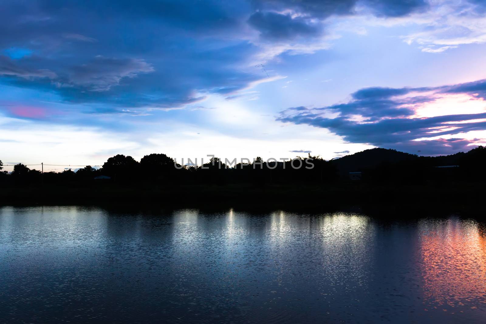 Reflection magic of colour sky and cloud in the river at twiligh by nopparats