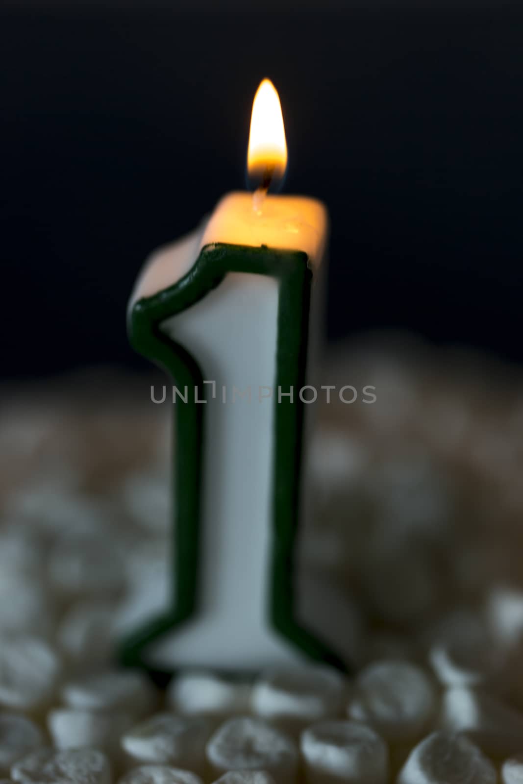 First Birthday Candle Burning. The number one.