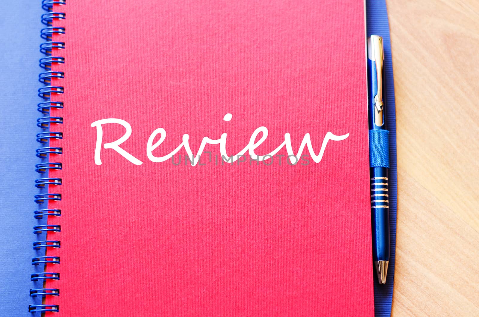 Notepad and pen on wooden background and text concept