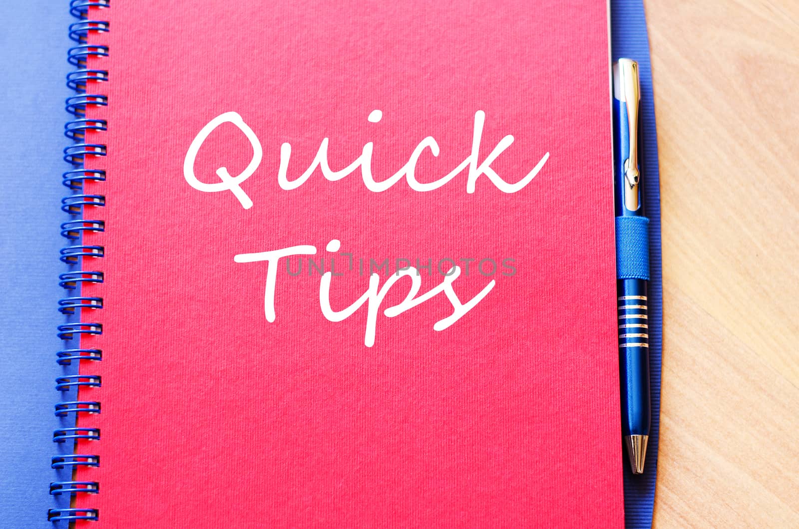 Notepad and pen on wooden background and text concept