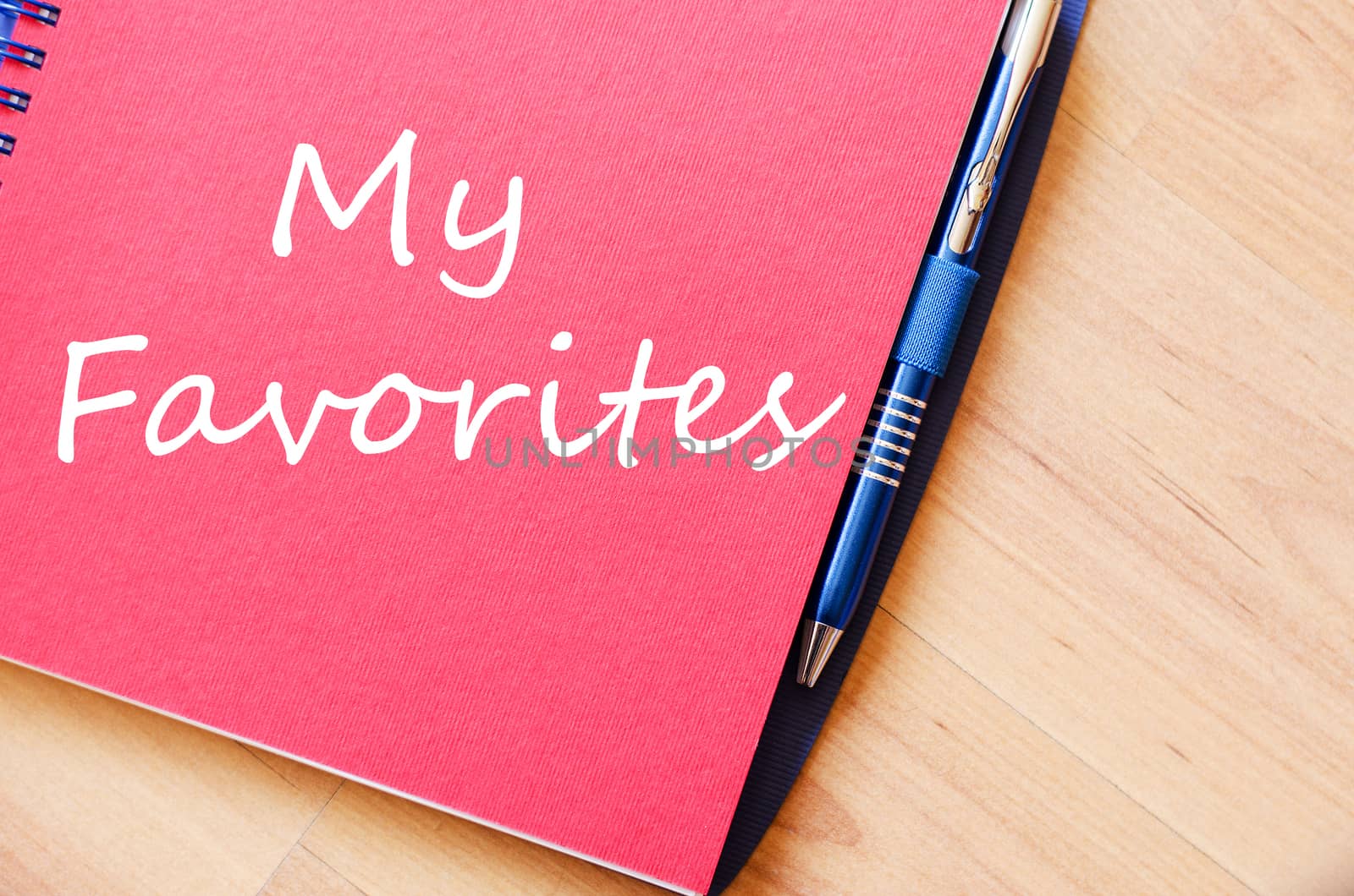 Notepad and pen on wooden background and text concept