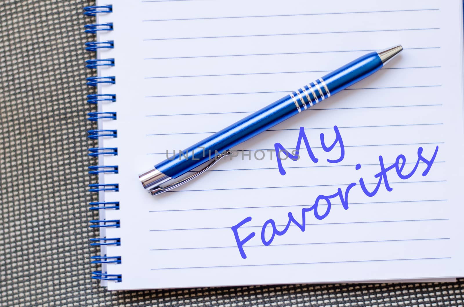 Notepad and pen on wooden background and text concept