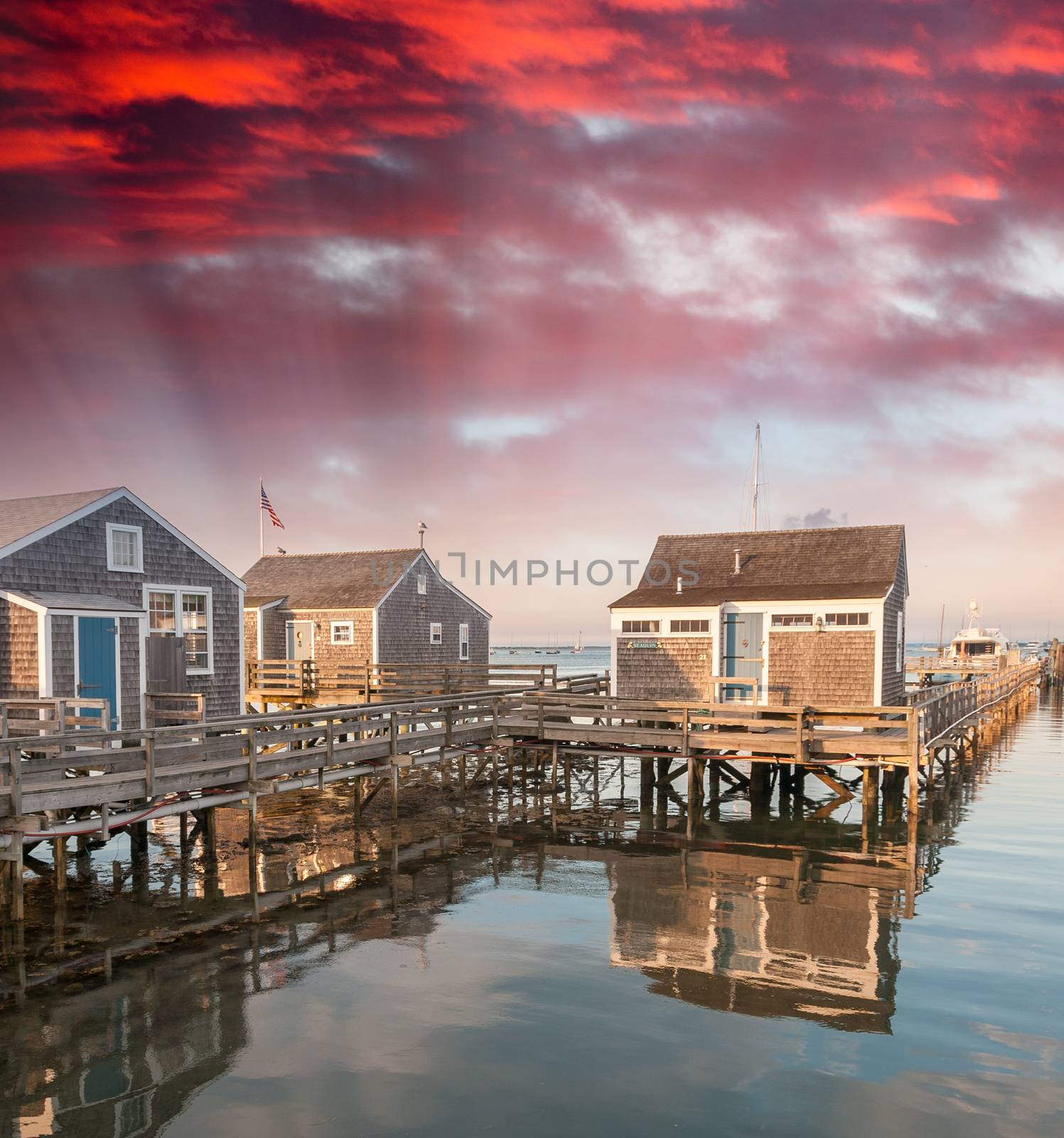 Wooden Homes over water at sunset by jovannig