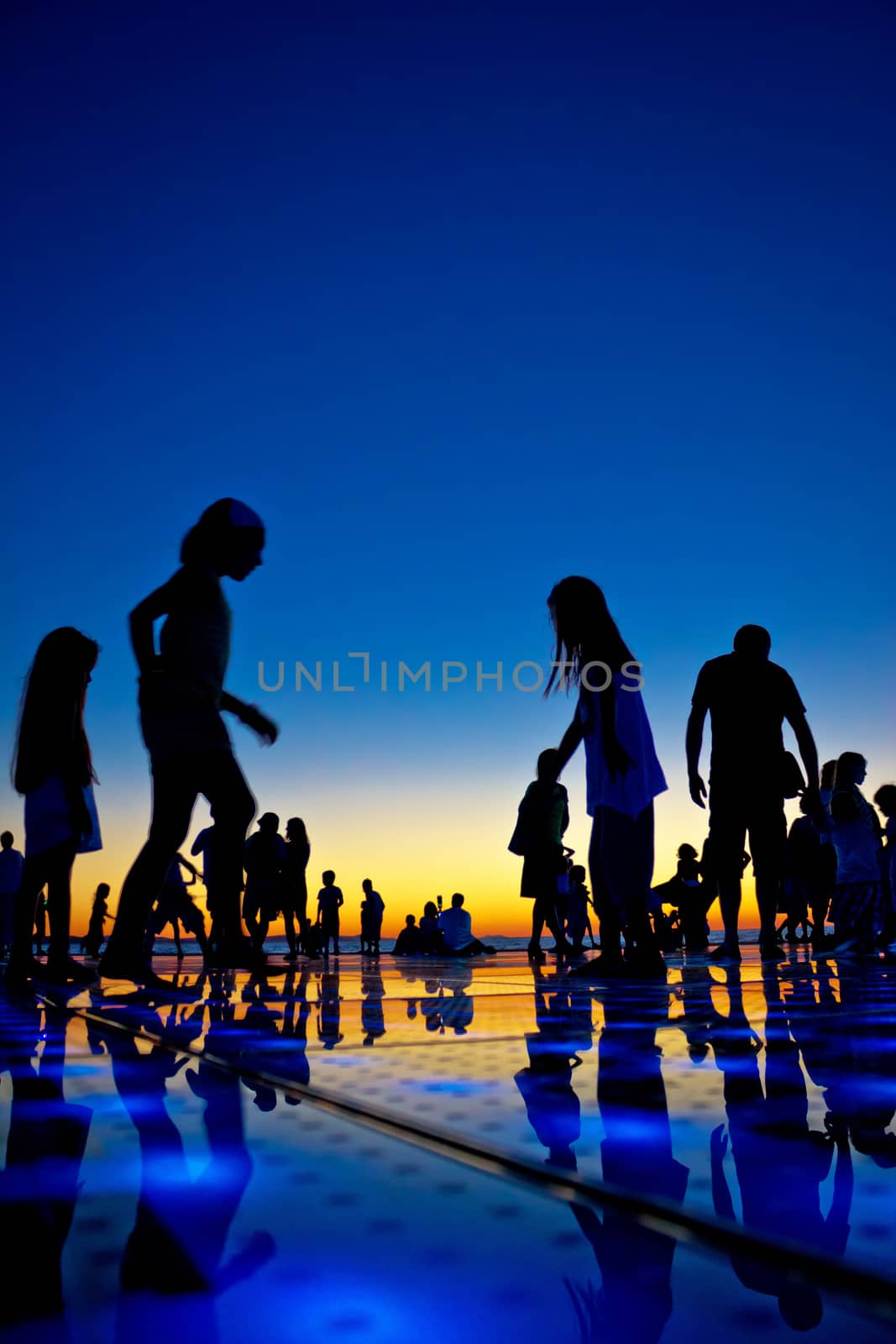 People silhouette on colorful sunset by xbrchx