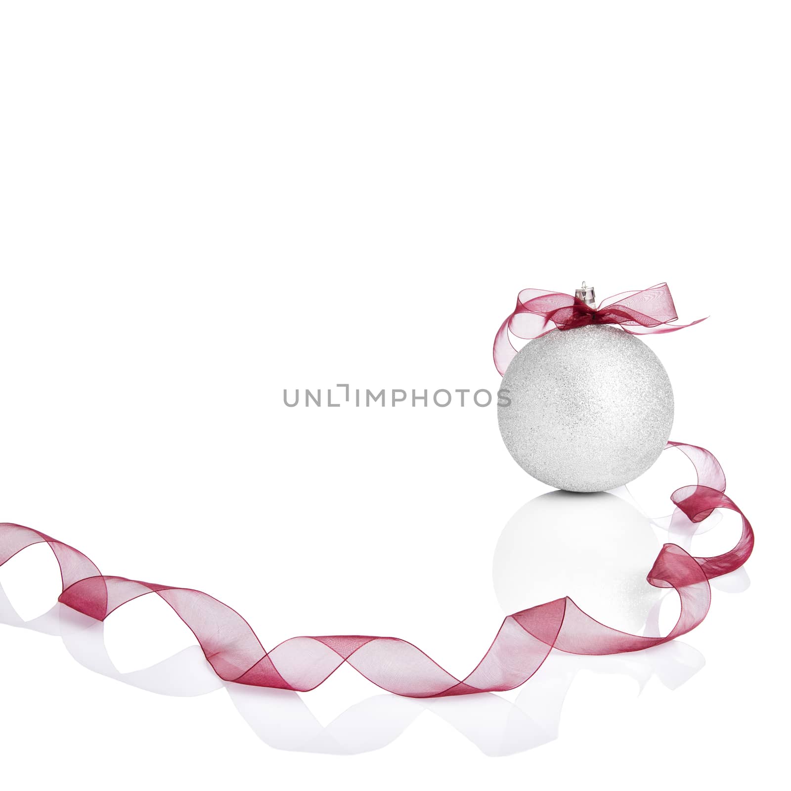 Silver Christmas ball with red bow. White copy space for your text and logo.