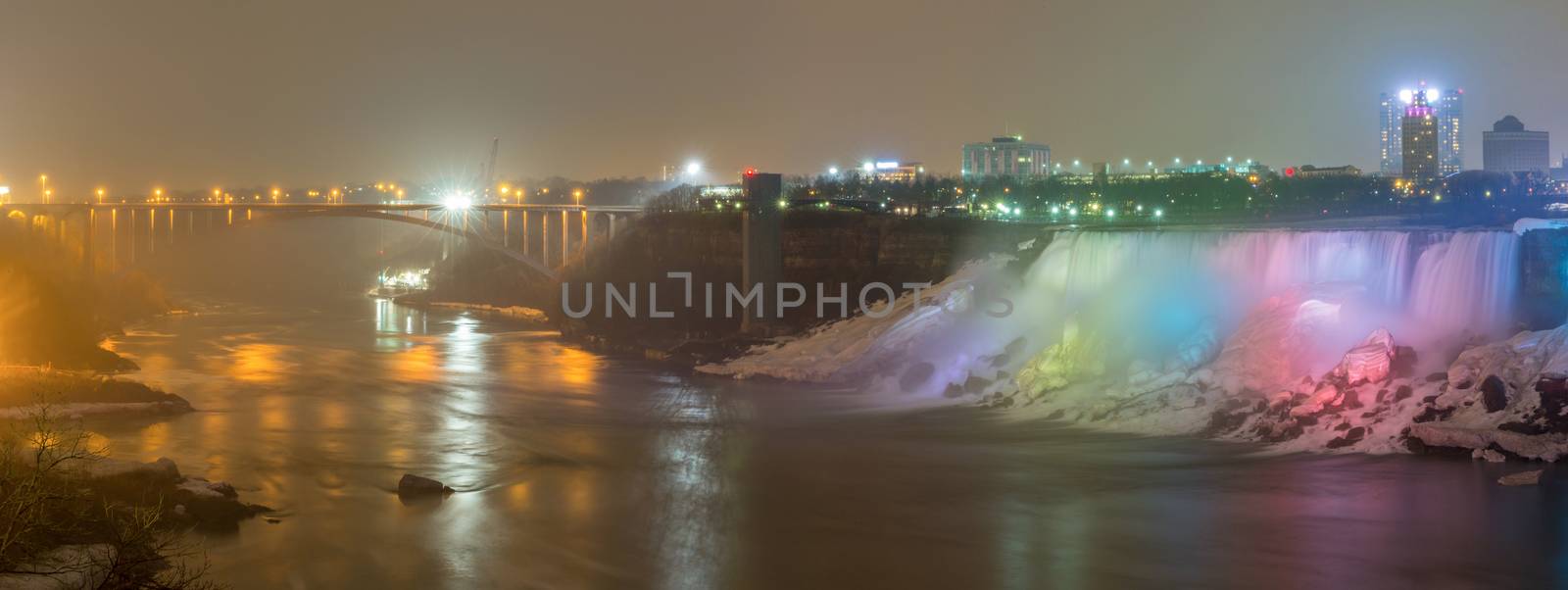 Panorama Illumination light of american Falls as viewed from Table Rock in Queen Victoria Park in Niagara Falls at night, Ontario, Canada 