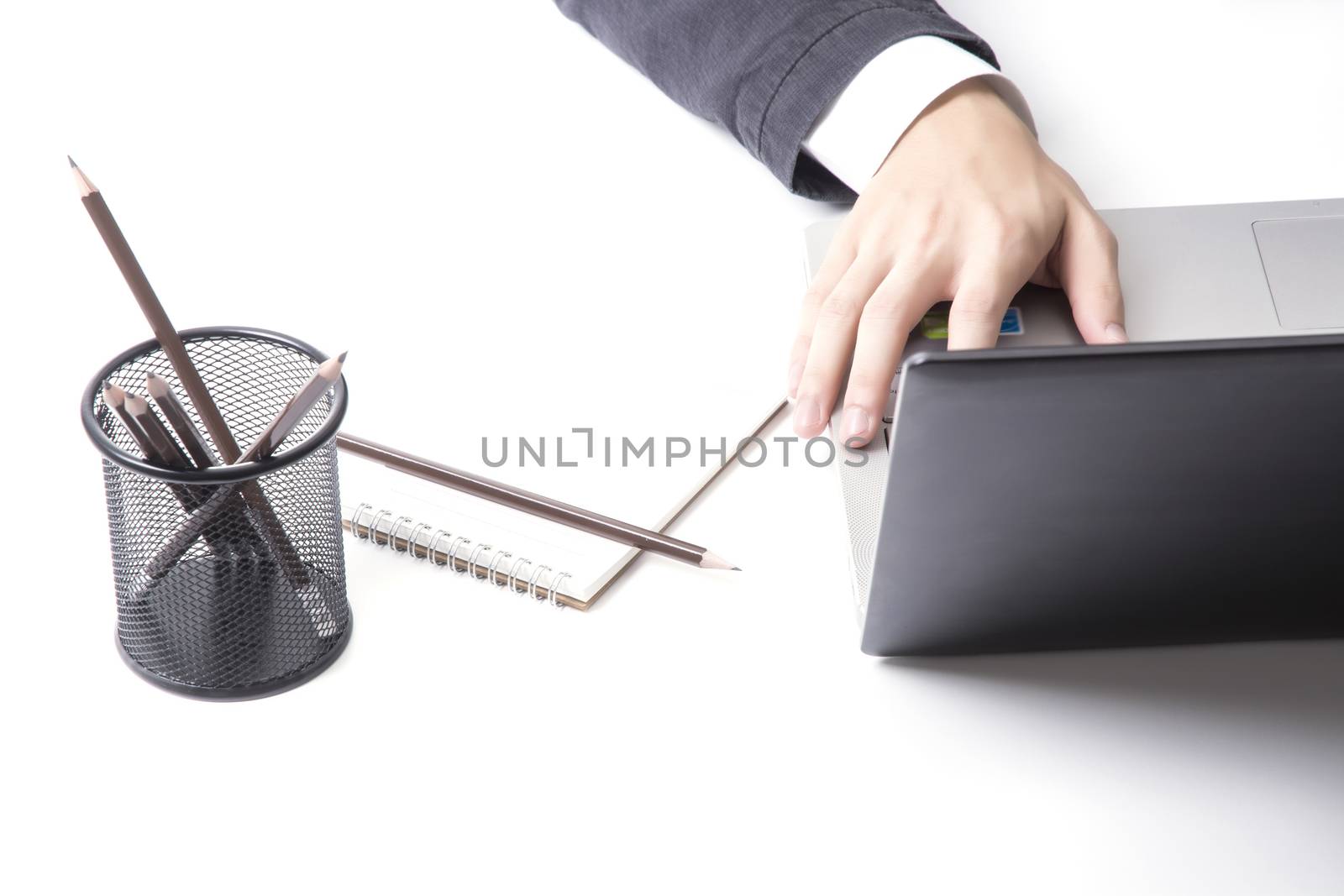 Asian man's hands typing on laptop keyboard