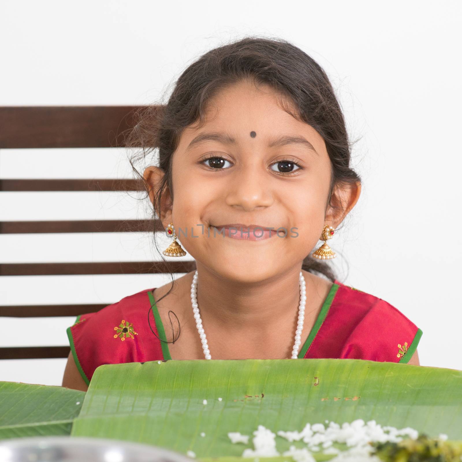 Indian family dining at home. Photo of Asian child eating rice. India culture.