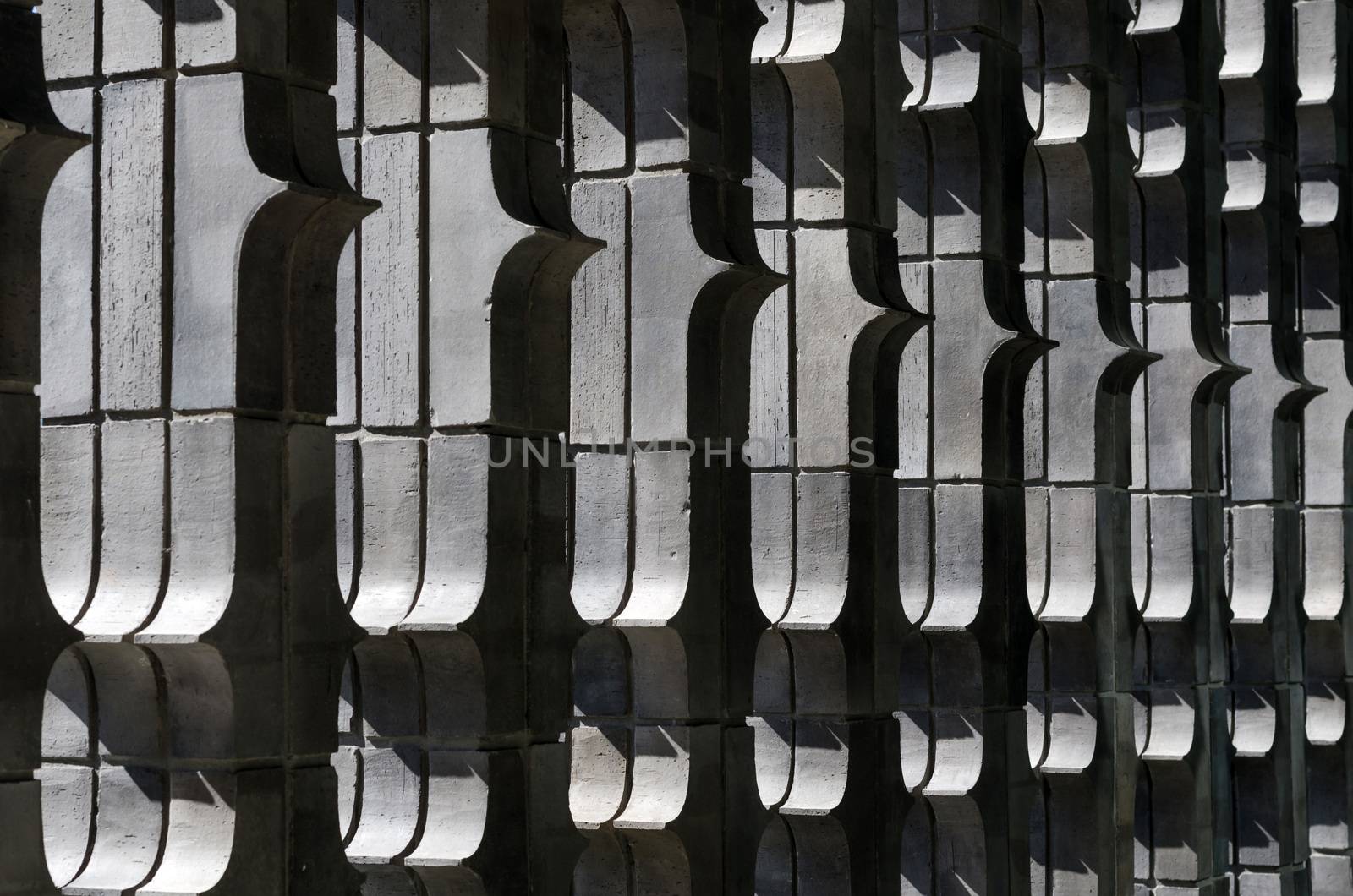 Extruded brick wall with light, vertical arrangements