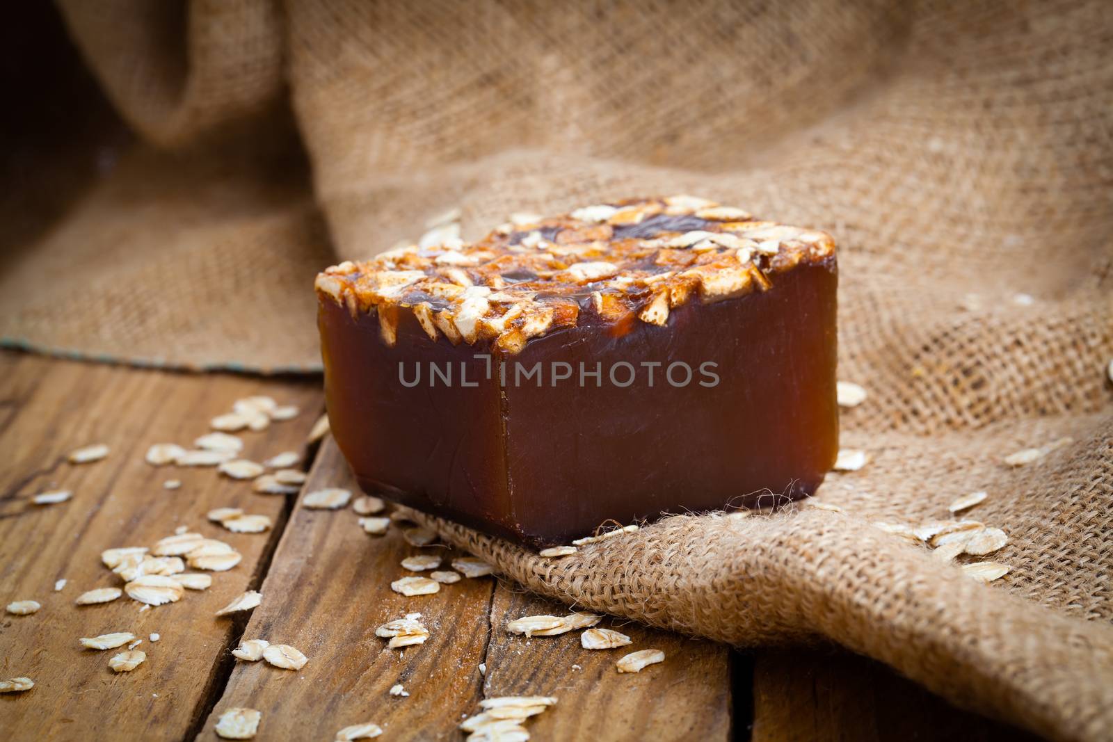 Single soap bar on wooden background