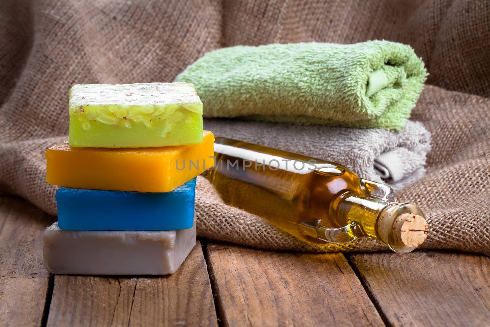 colorful handmade soap bars with oil, on wooden background