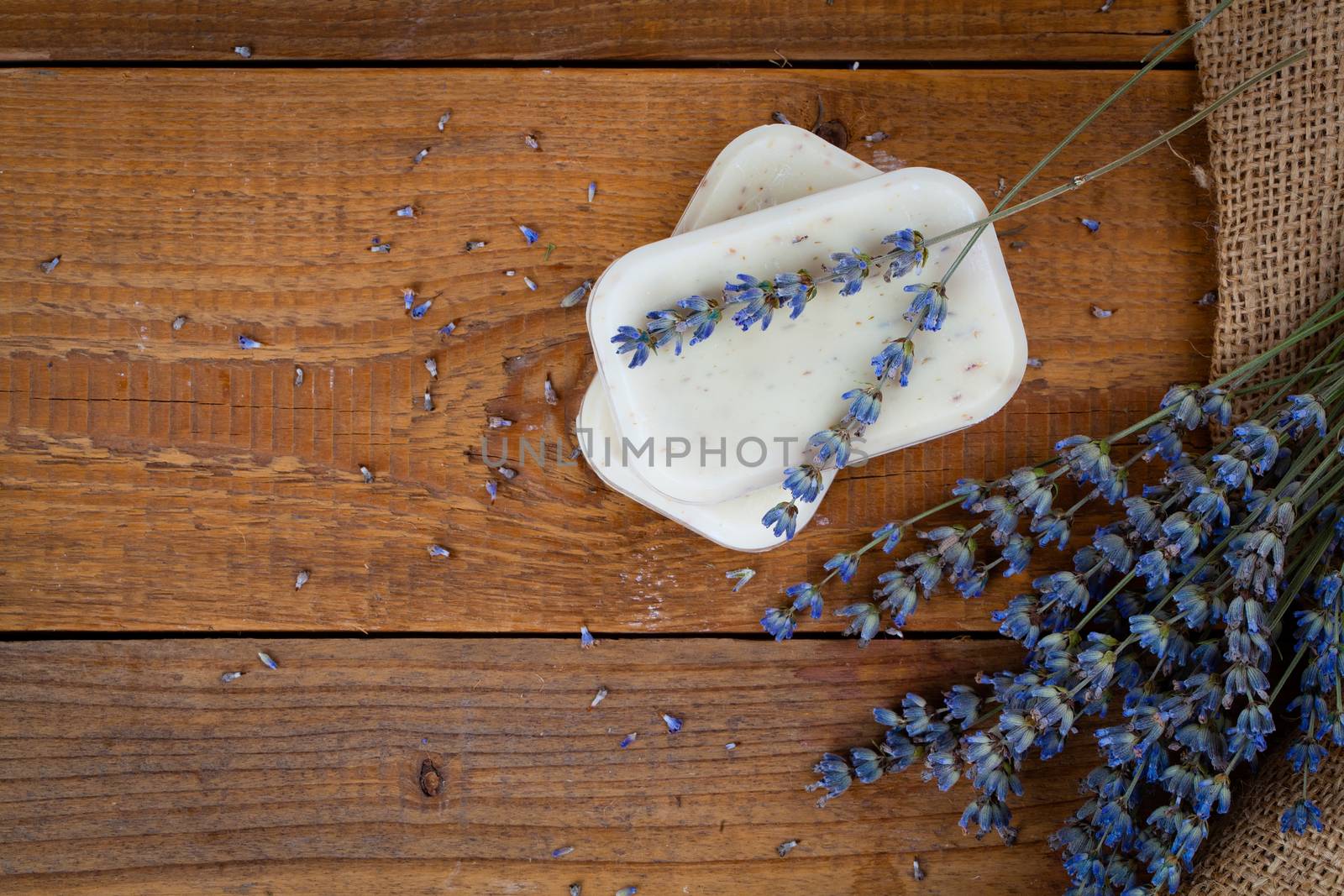 Bars of soap with lavender on a rustic wooden background