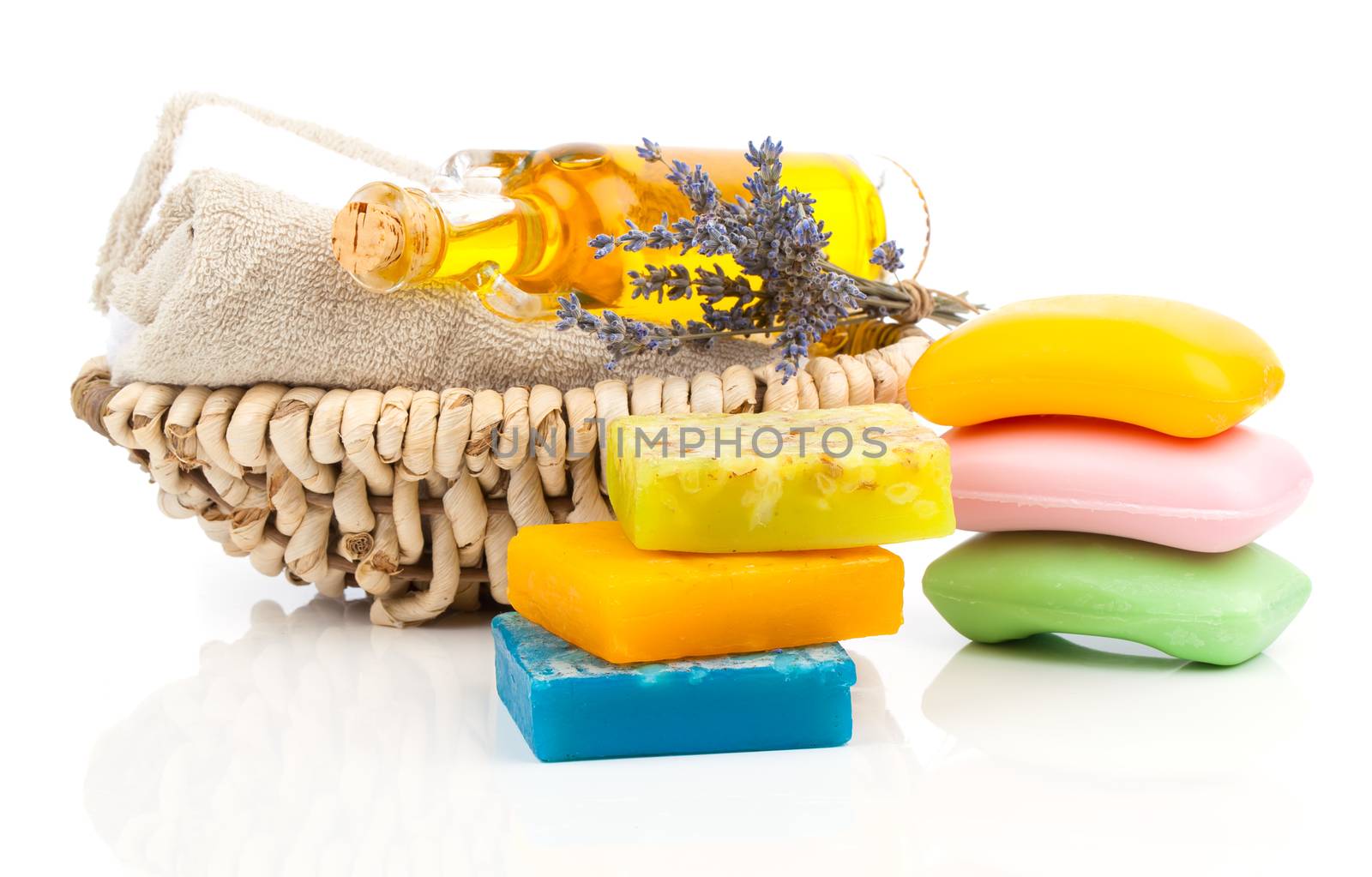 Spa still life with handmade soaps, lavender flowers and oil, on white background