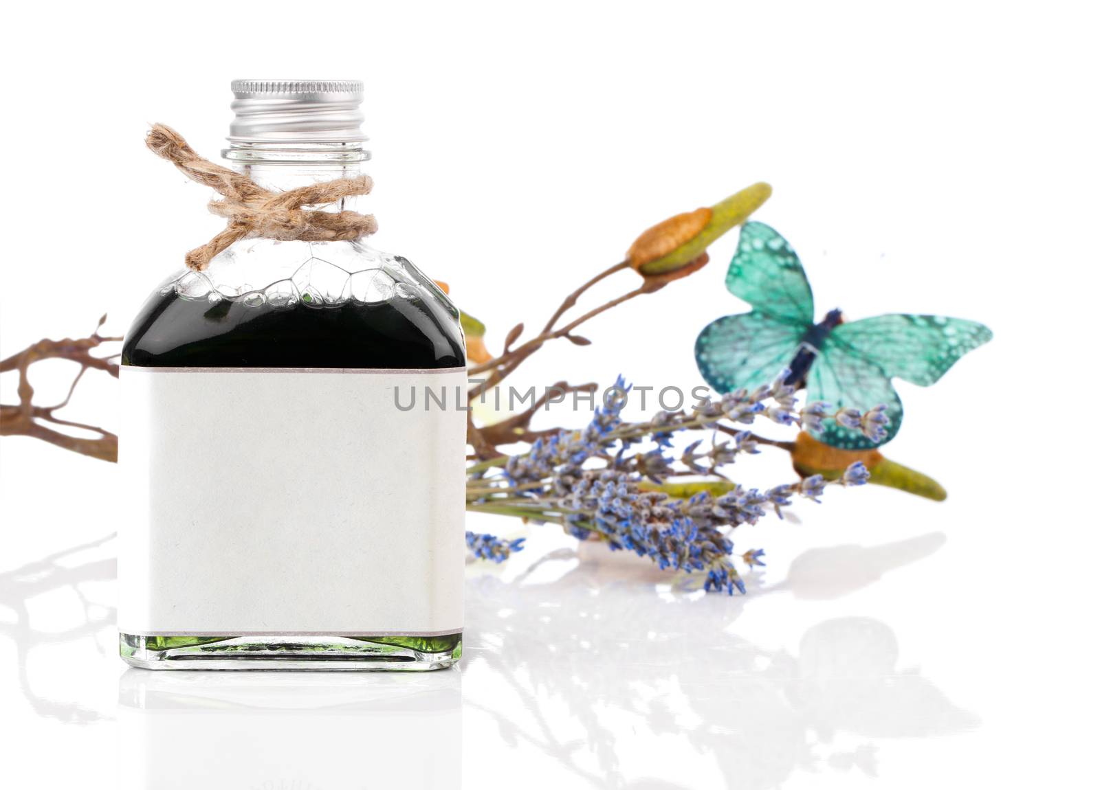Spa still life with lavender oil and flowers on white background