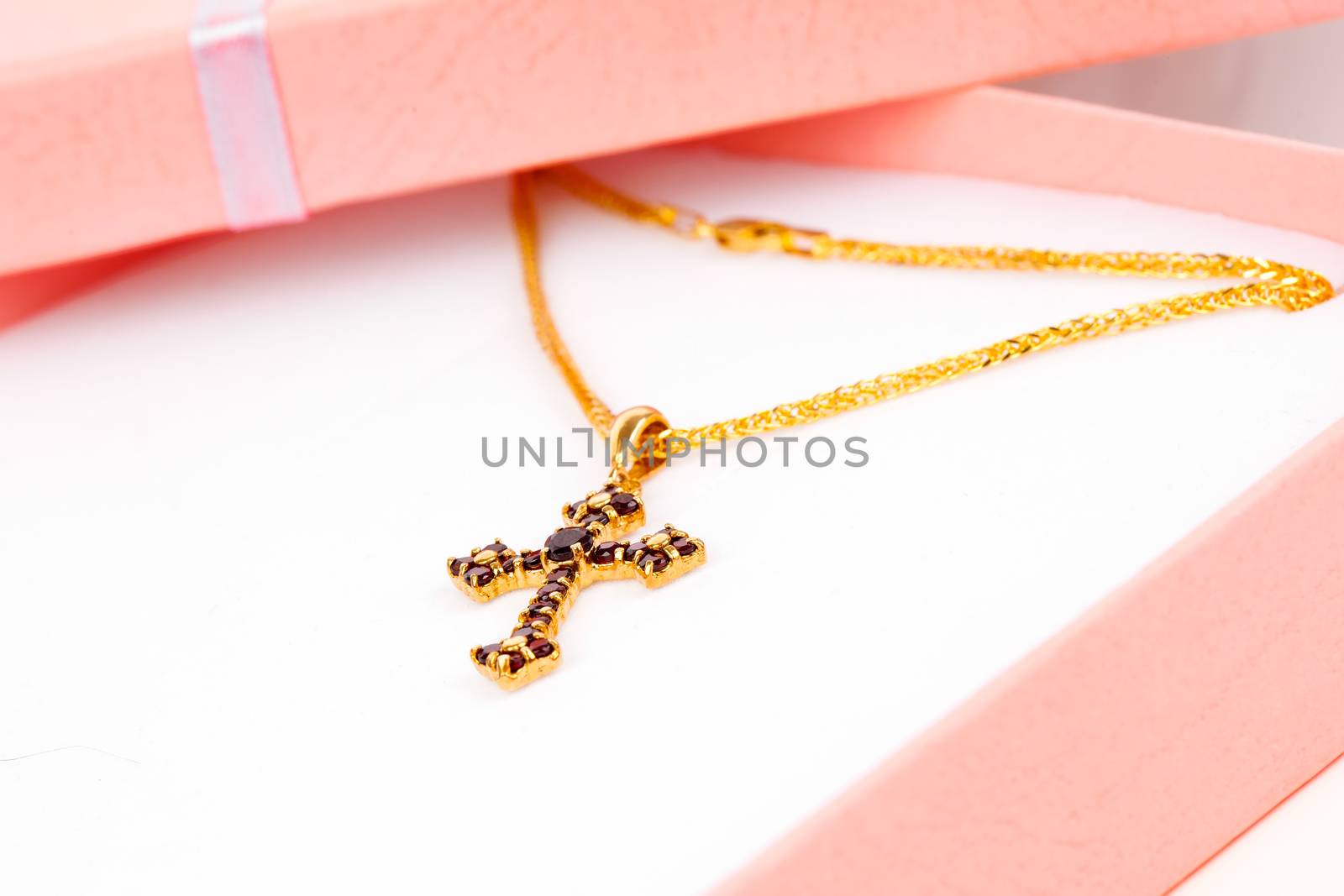 Golden Cross with garnets in packaged by motorolka