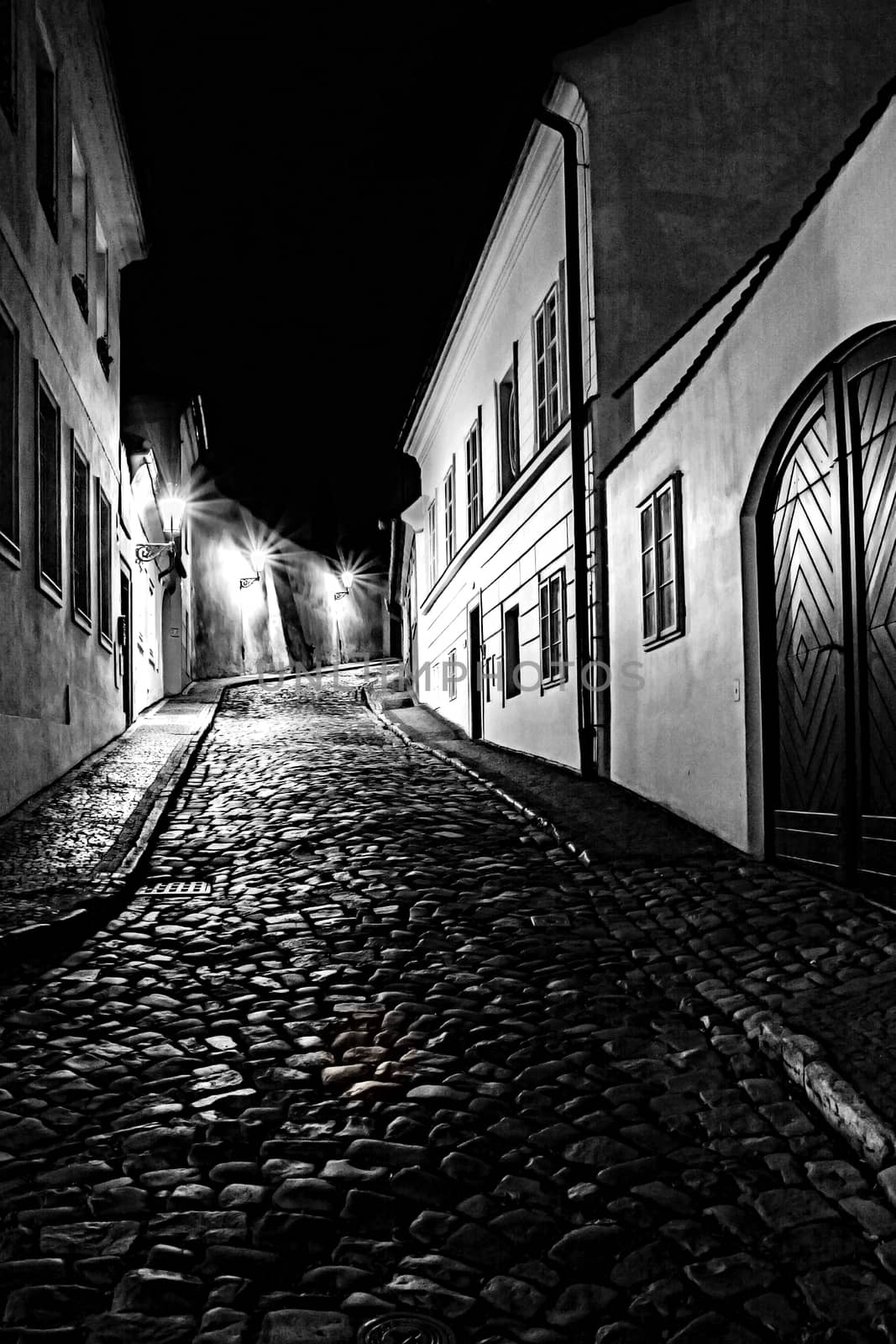 mysterious narrow alley with lanterns in Prague at night

