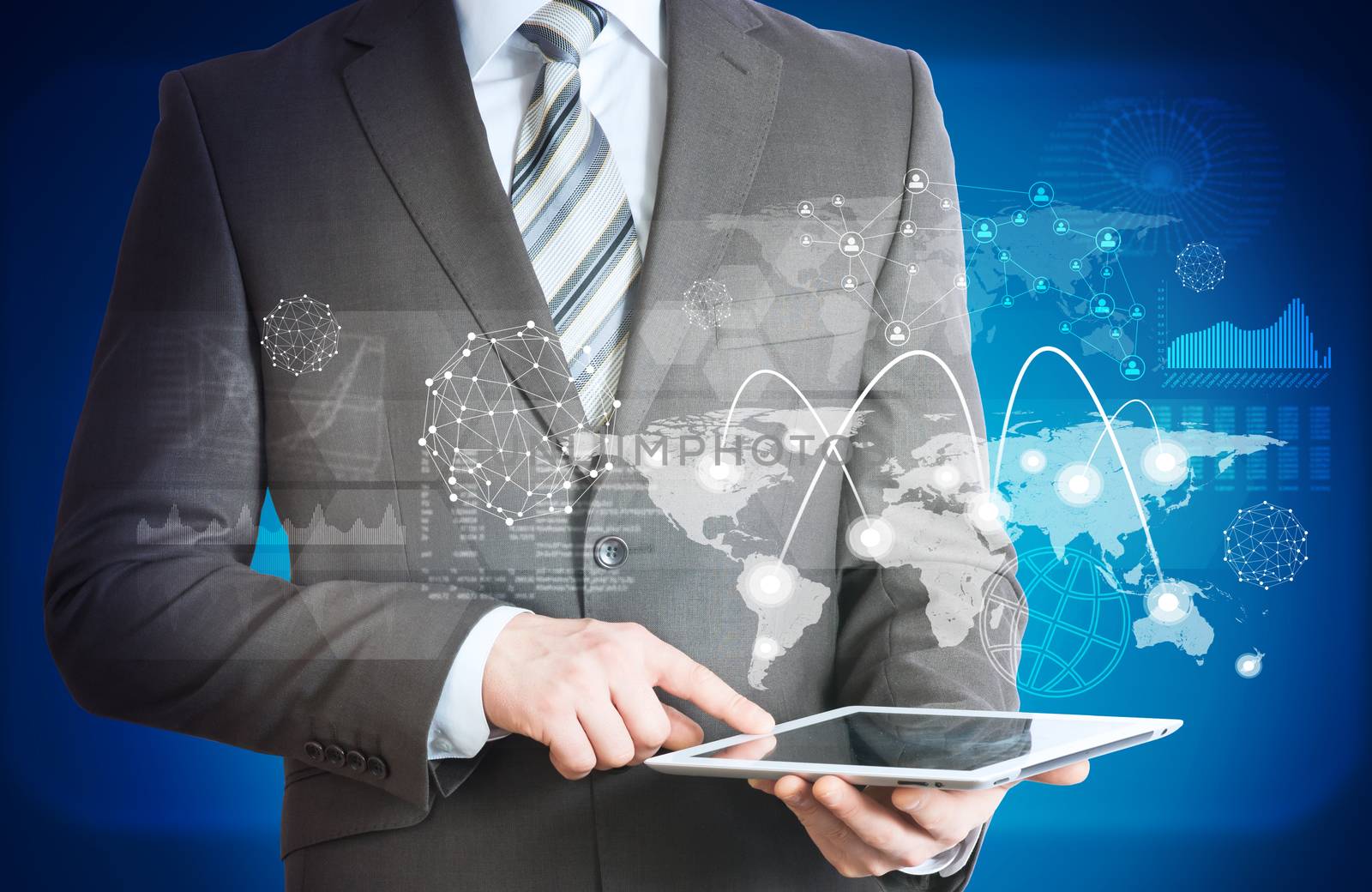 Businessman holding tablet with world map and graphs