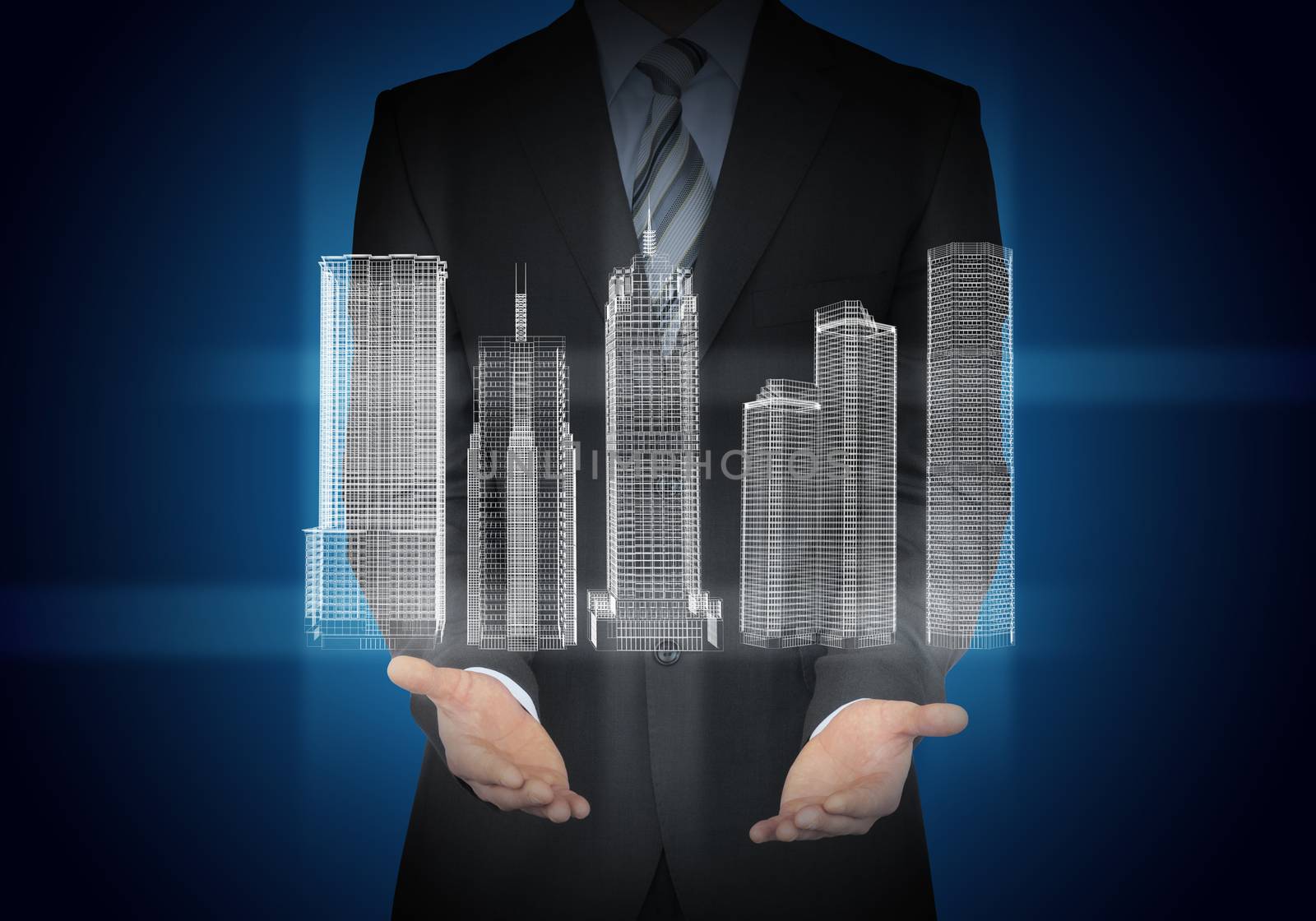 Businessman with 3d model of city in hands on abstract blue background