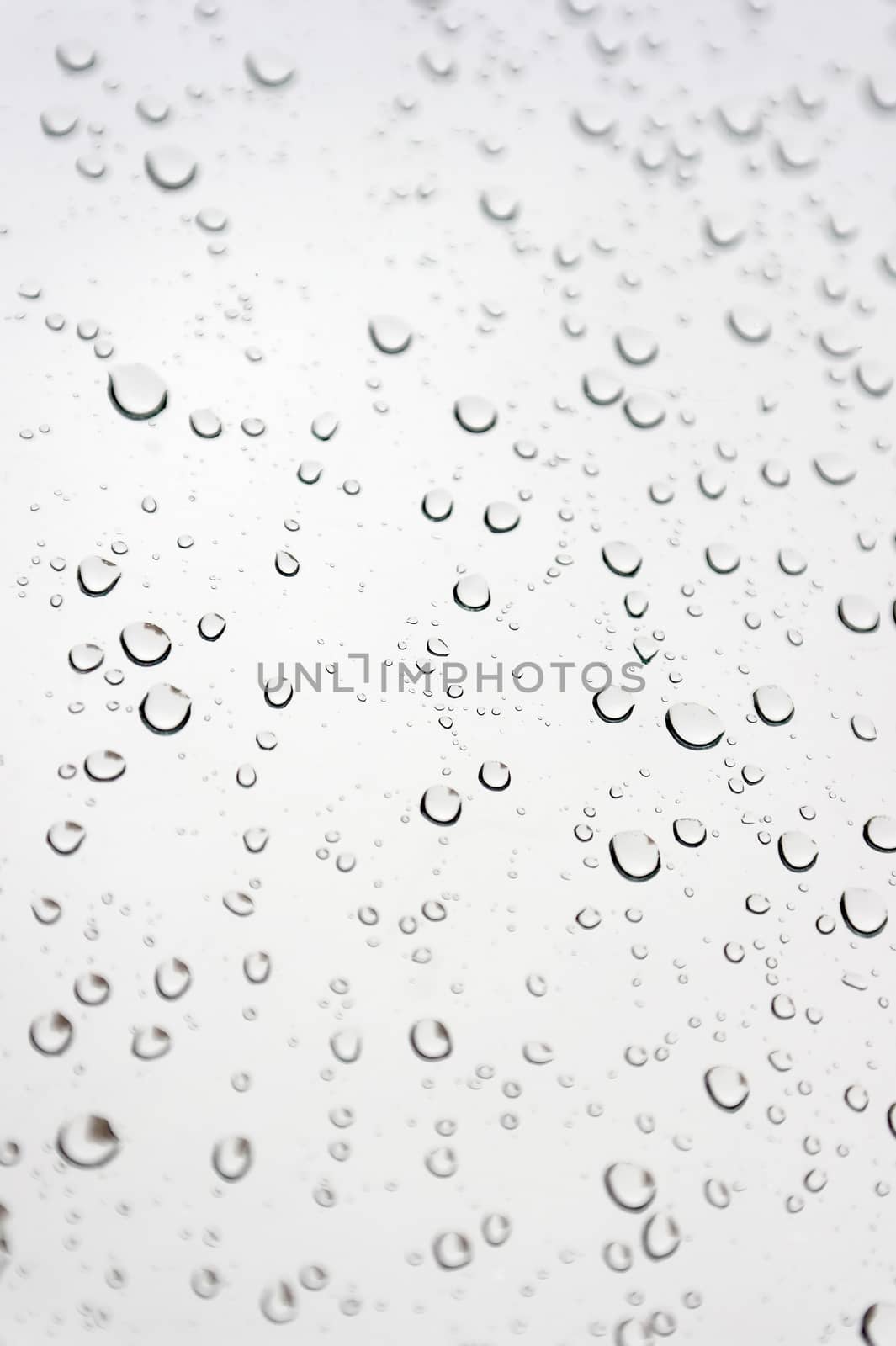 Drops of rain on the inclined window, shallow dof