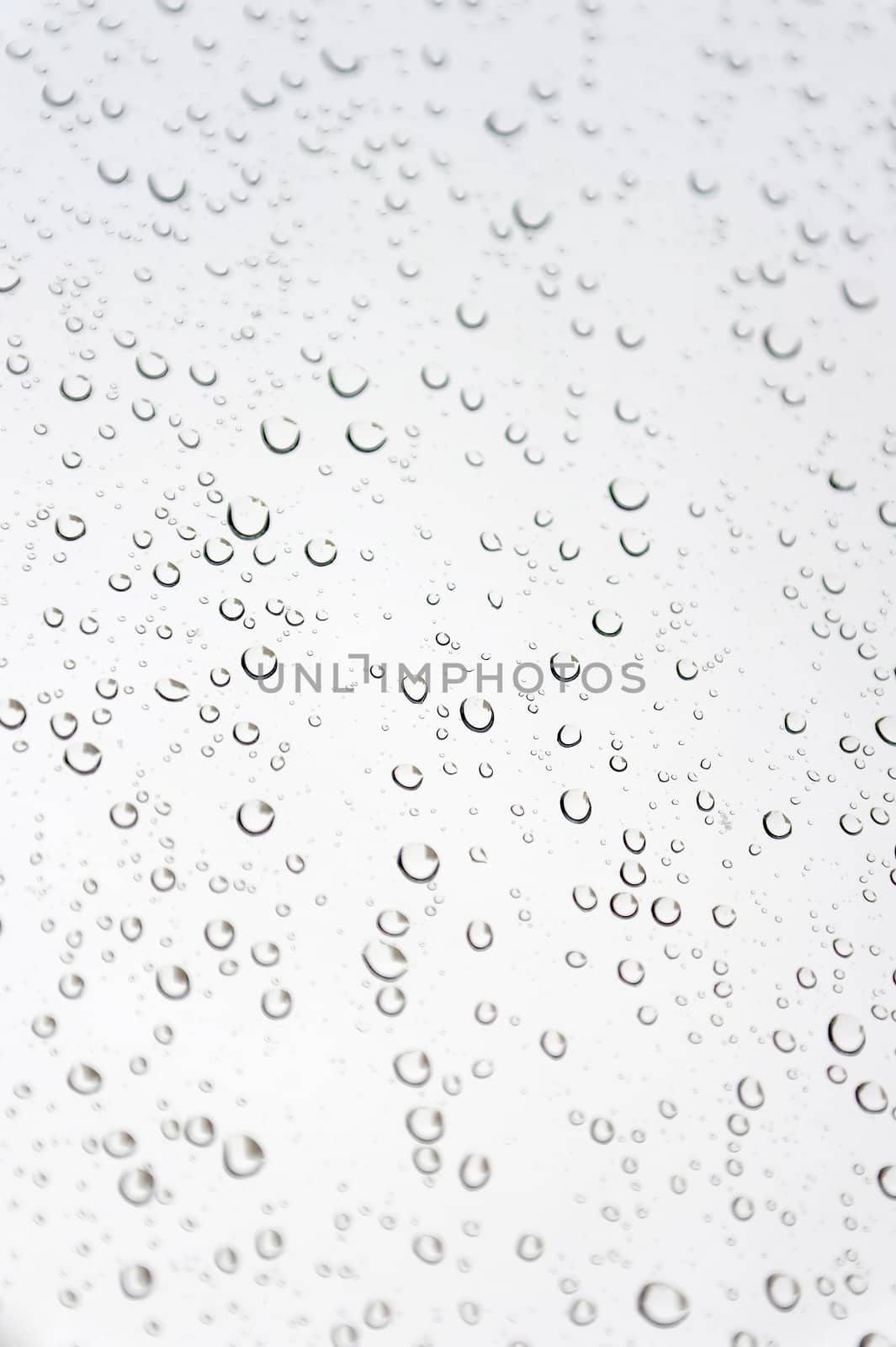 Drops of rain on the inclined window, shallow dof